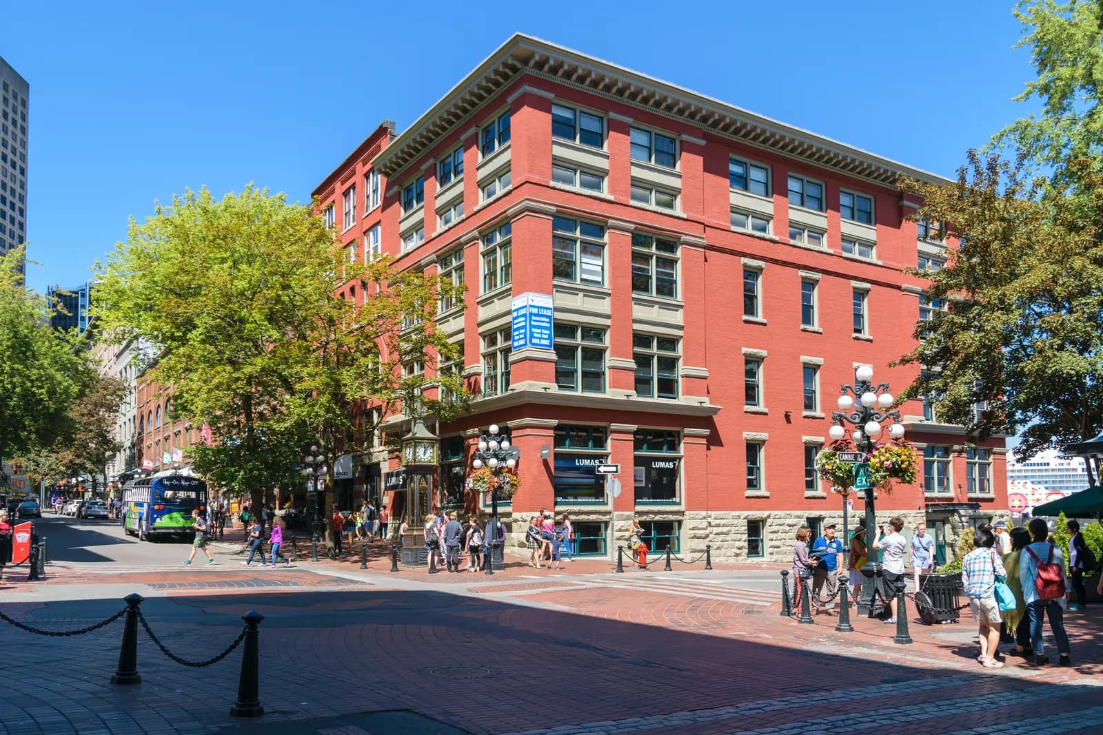 Victorian brick buildings and cast iron lamp posts on a brick paved street in Vancouver's Gastown