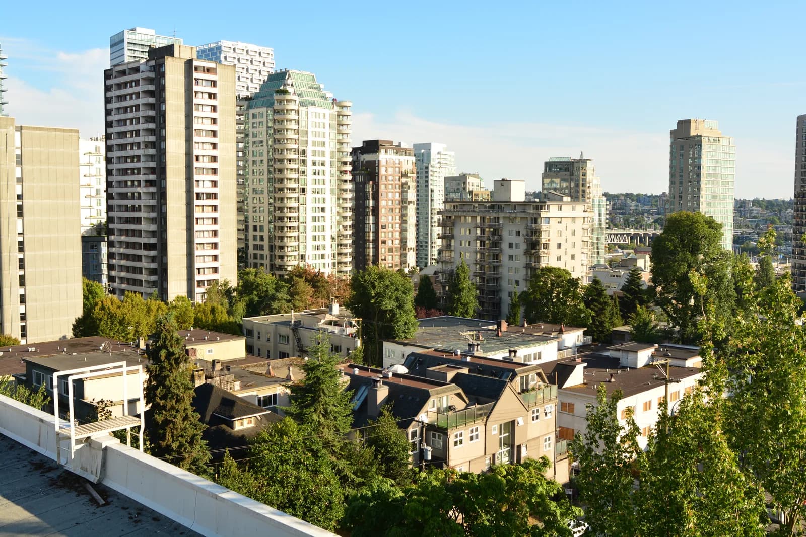Apartment towers rising above tree lined streets and older low rise houses in Vancouver's West End