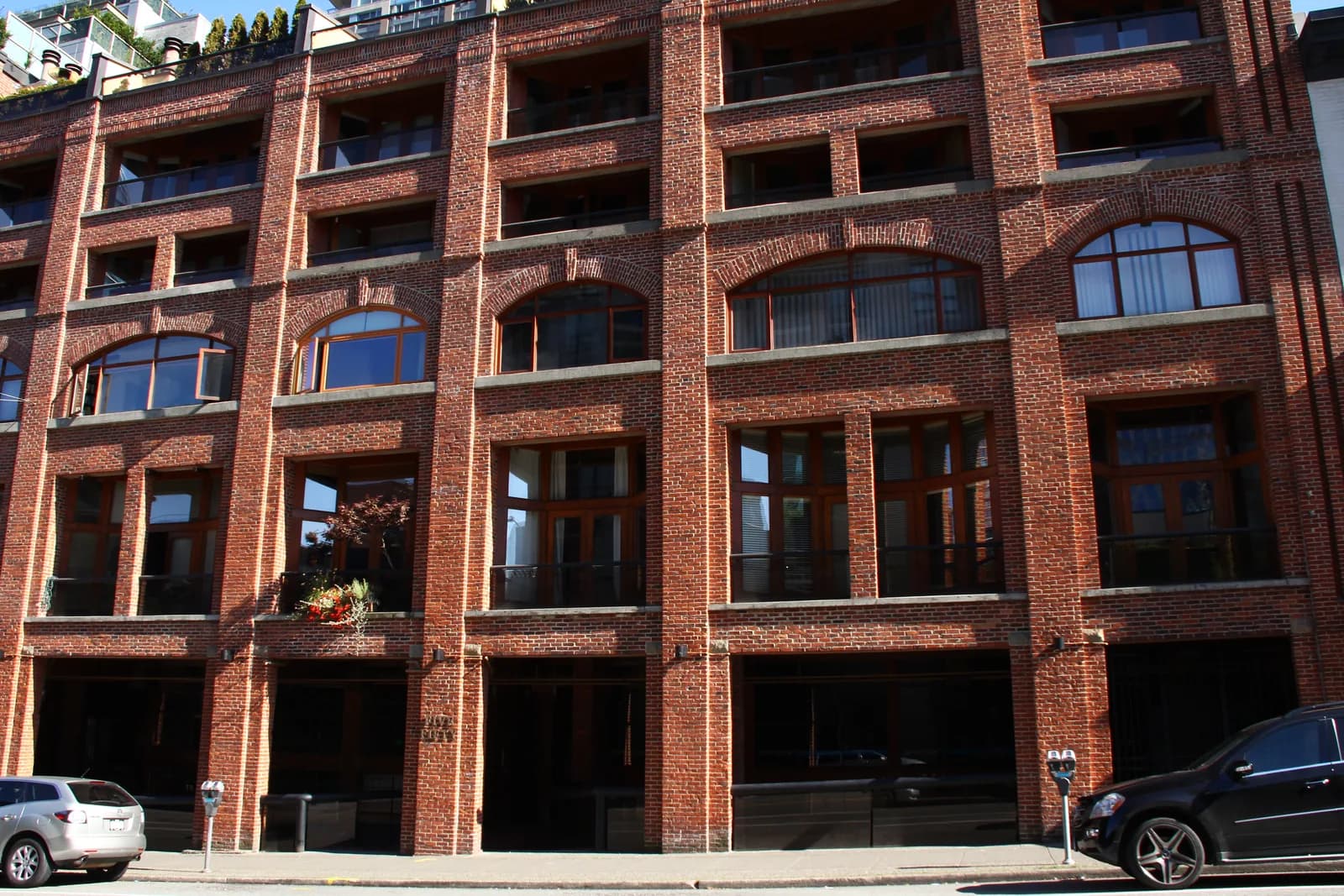 A converted brick warehouse with arched windows and loading bays in Vancouver's Yaletown area