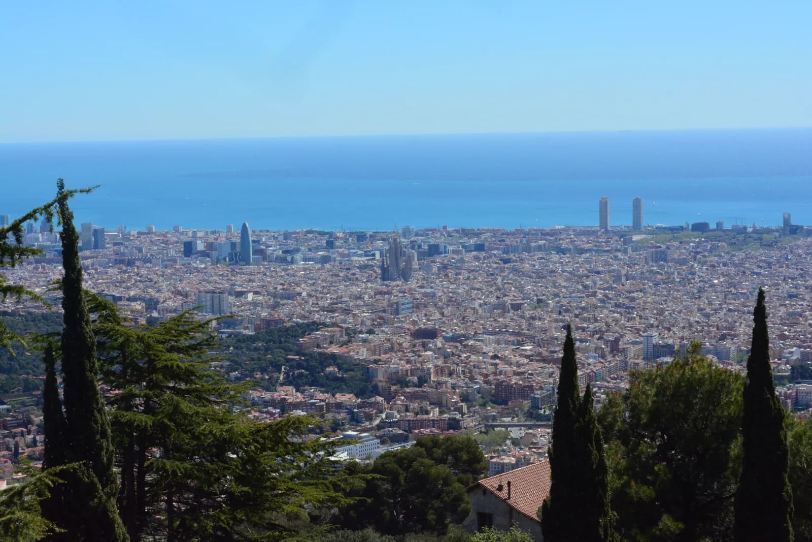 Barcelona seen from above with the Sagrada Familia rising over the Eixample grid