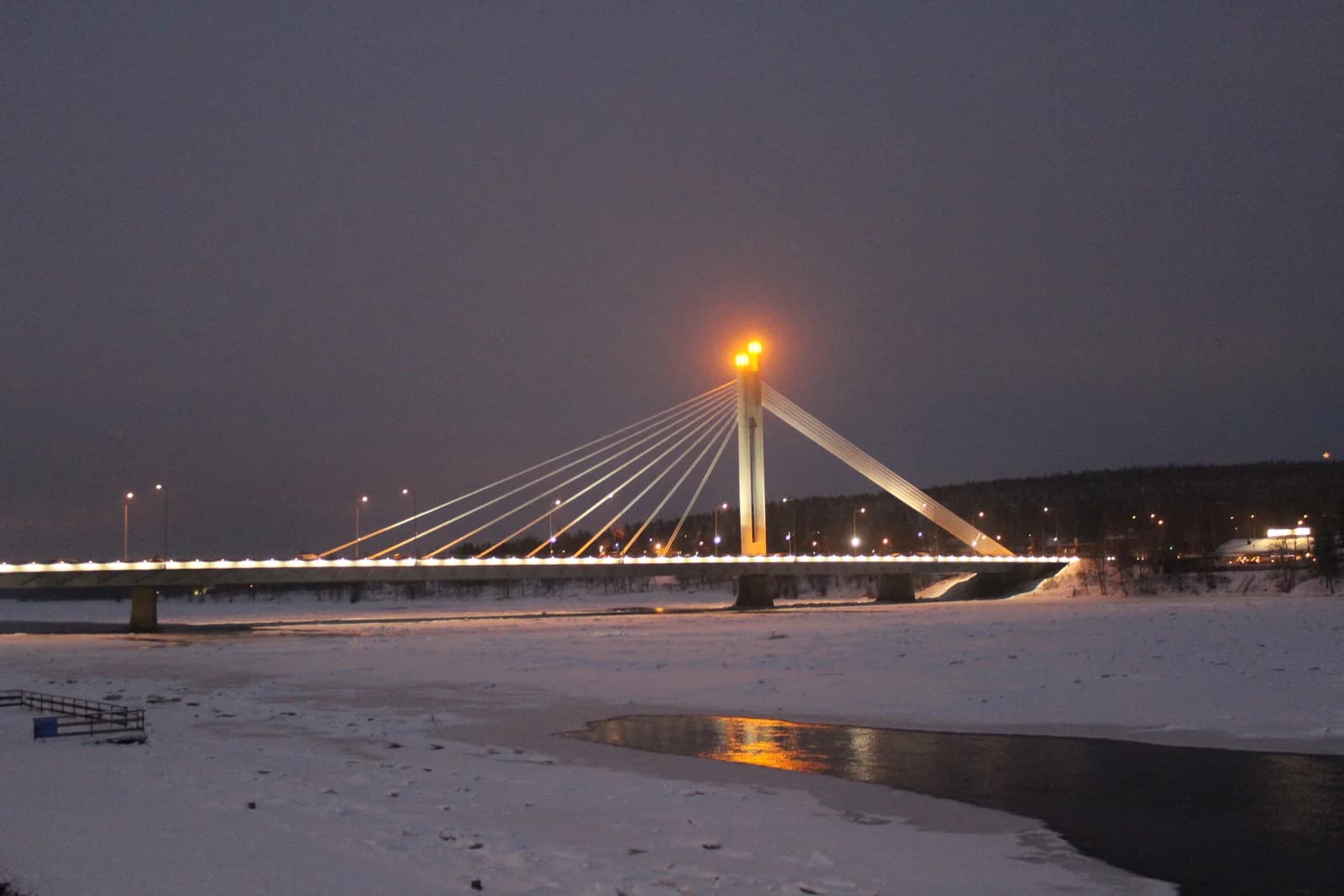 The lit candle bridge over a frozen river at Rovaniemi, the main arrival town for Finnish Lapland glass igloo stays
