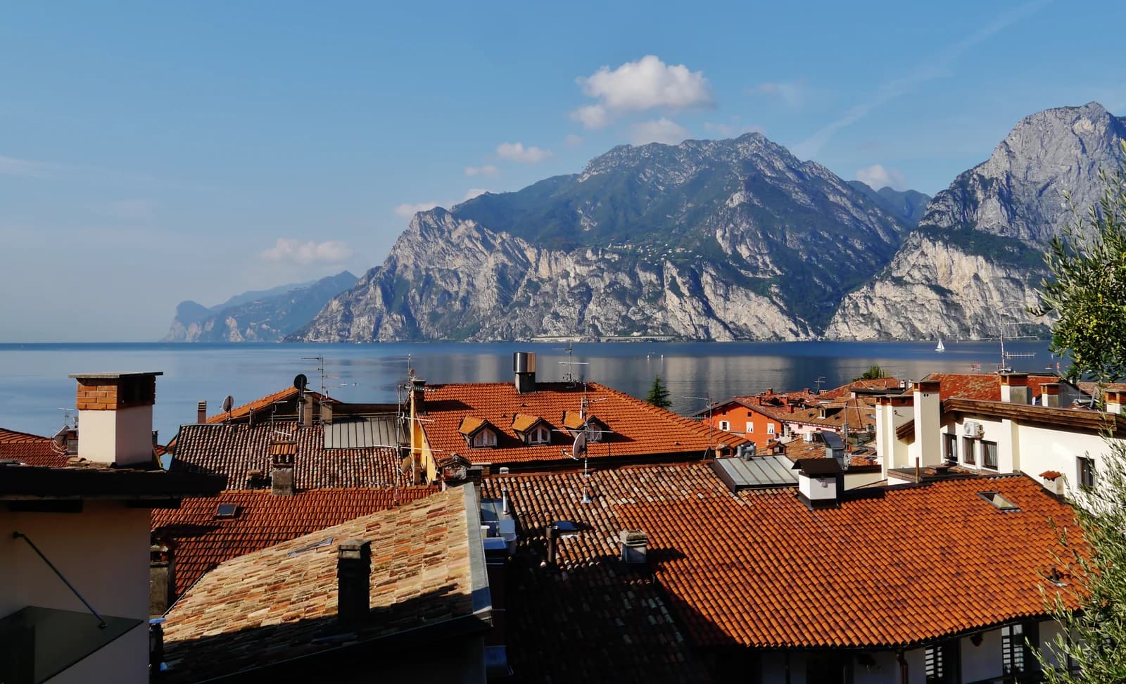 The northern end of Lake Garda from Nago-Torbole, with the cliffs above Riva del Garda across the water and the town's rooftops below