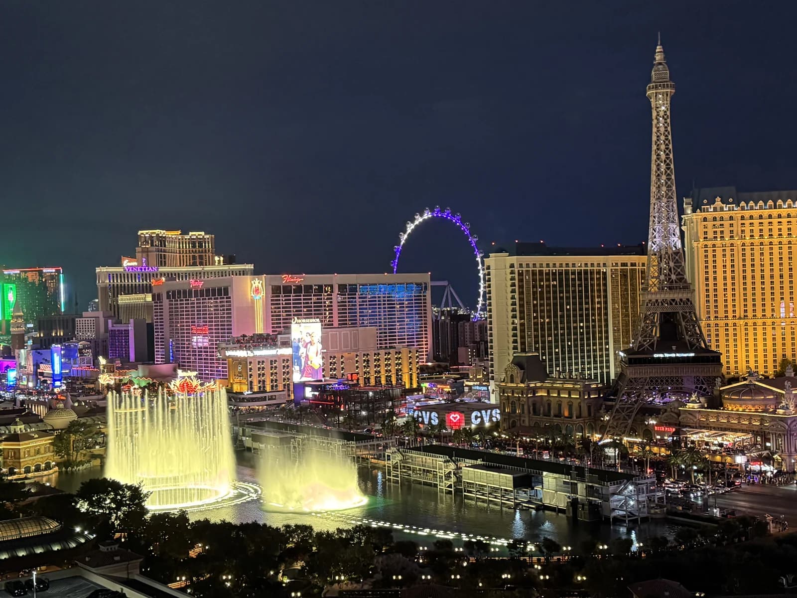 The Las Vegas Strip by day, resort towers lining the boulevard with the desert mountains behind them