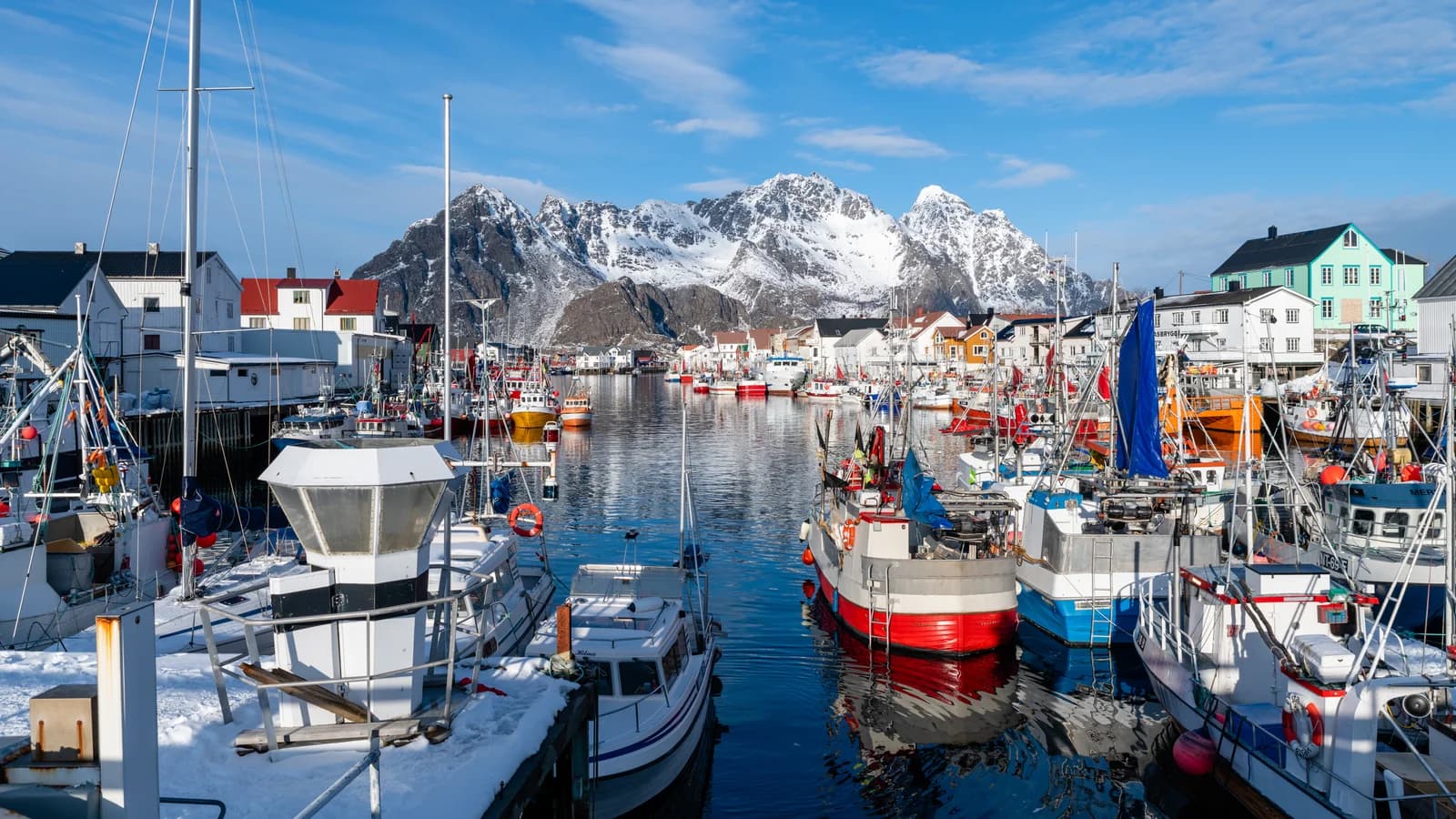 The fishing village of Henningsvaer in Lofoten, timber houses on low rocky islets with the sea between them