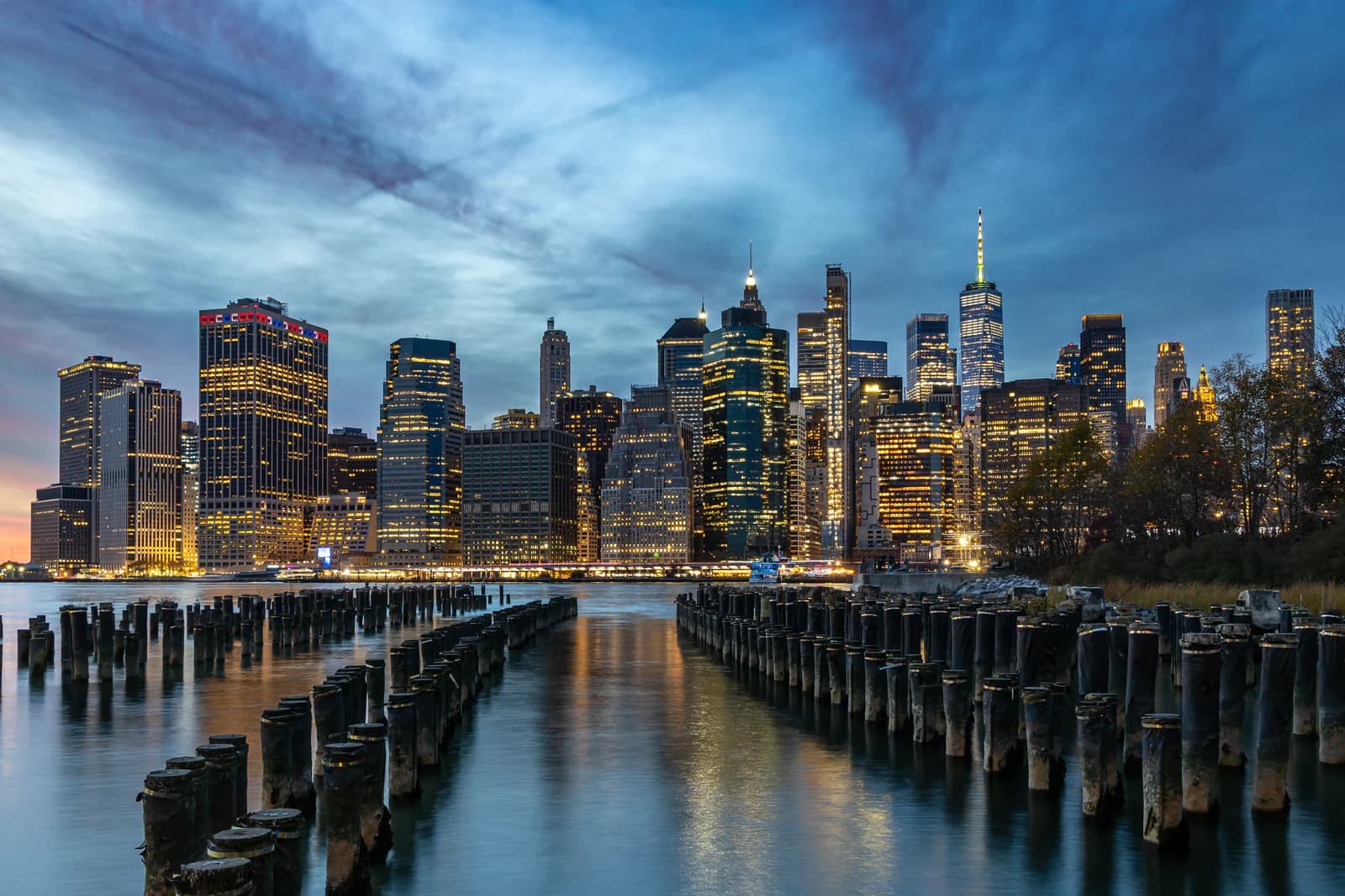 Lower Manhattan's skyline at dusk from Brooklyn Bridge Park, the city the hotels on this page compete over