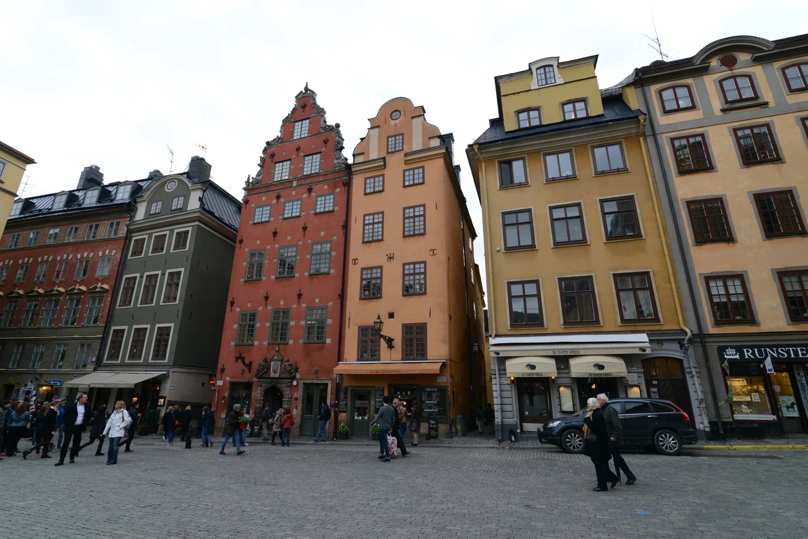 Tall narrow merchant houses in painted rows around Stortorget square in Stockholm's old town