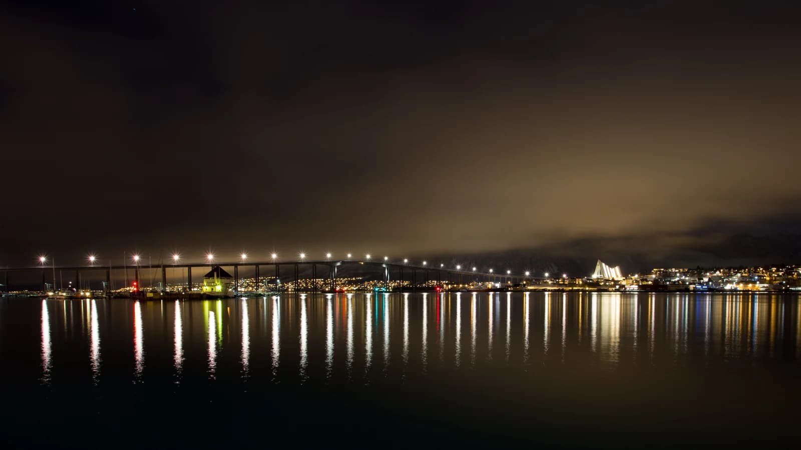 The lit Tromso bridge at night running across to Tromsdalen and the Arctic Cathedral