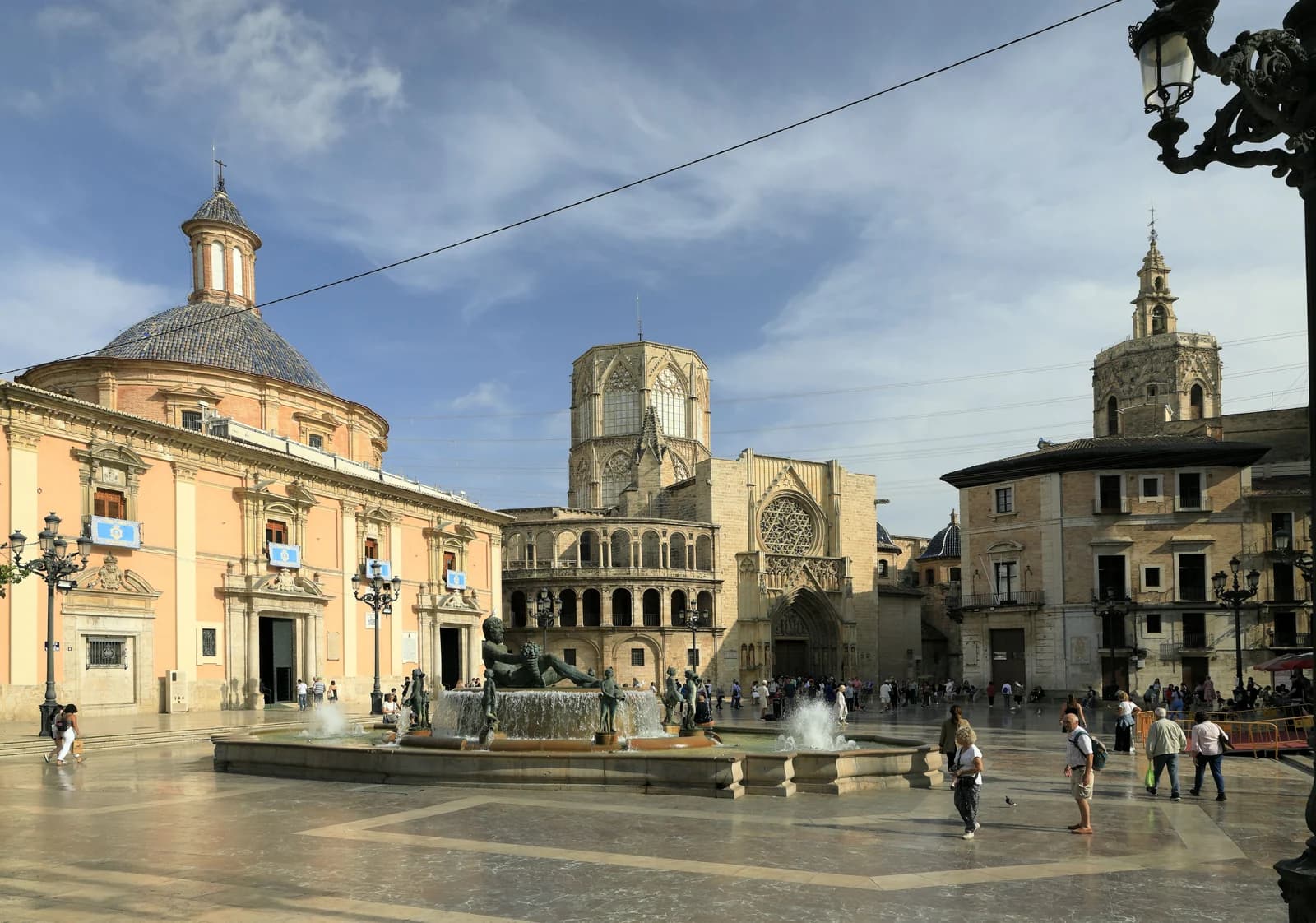 Plaza de la Virgen in the old centre of Valencia, cafe tables on the square below the cathedral and its bell tower