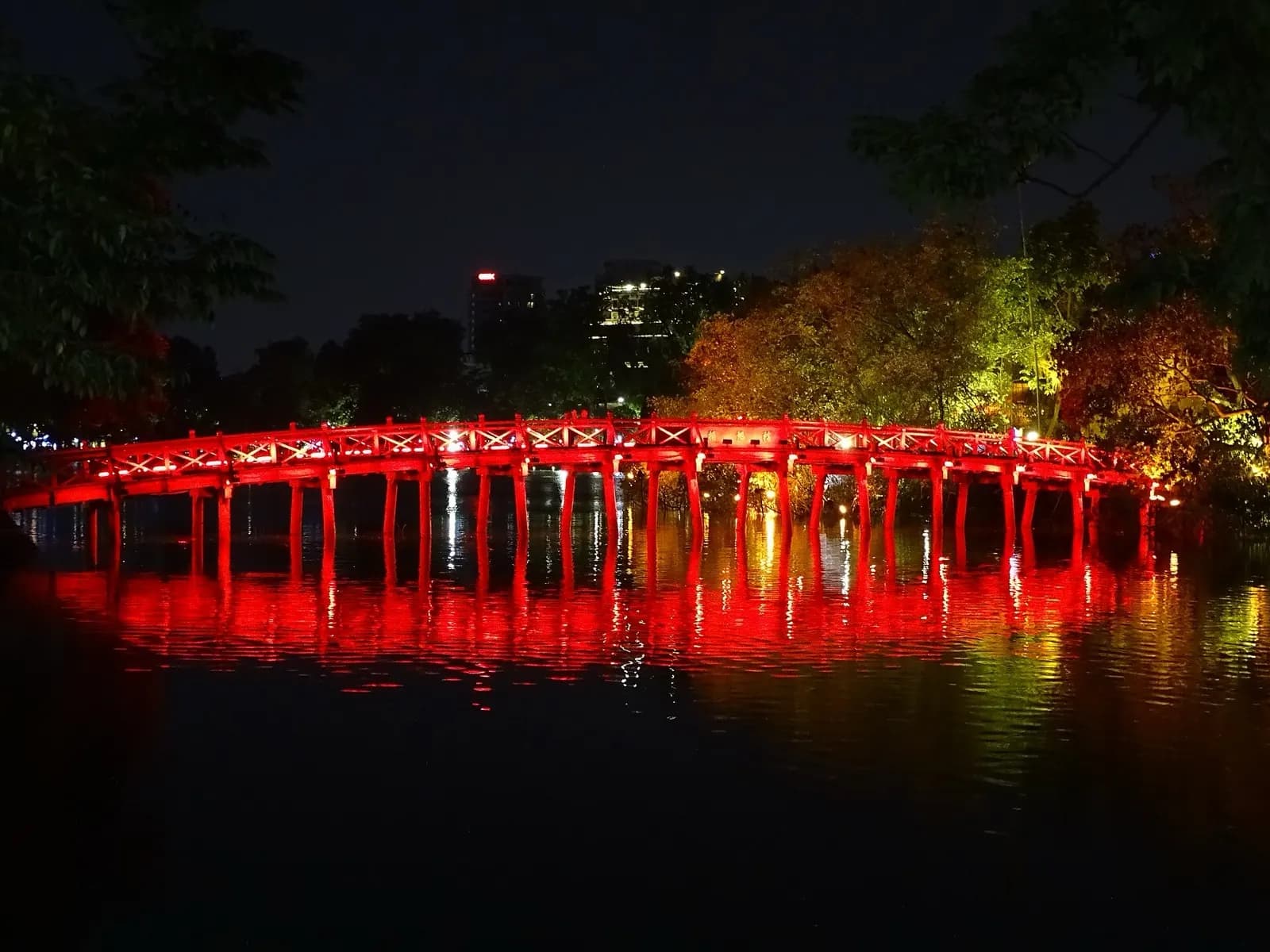 The illuminated bridge to Ngoc Son temple on Hoan Kiem Lake in Hanoi's Old Quarter at night