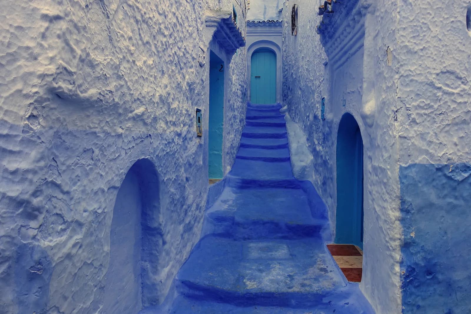 Blue-washed stepped alleyway in the medina of Chefchaouen, Morocco