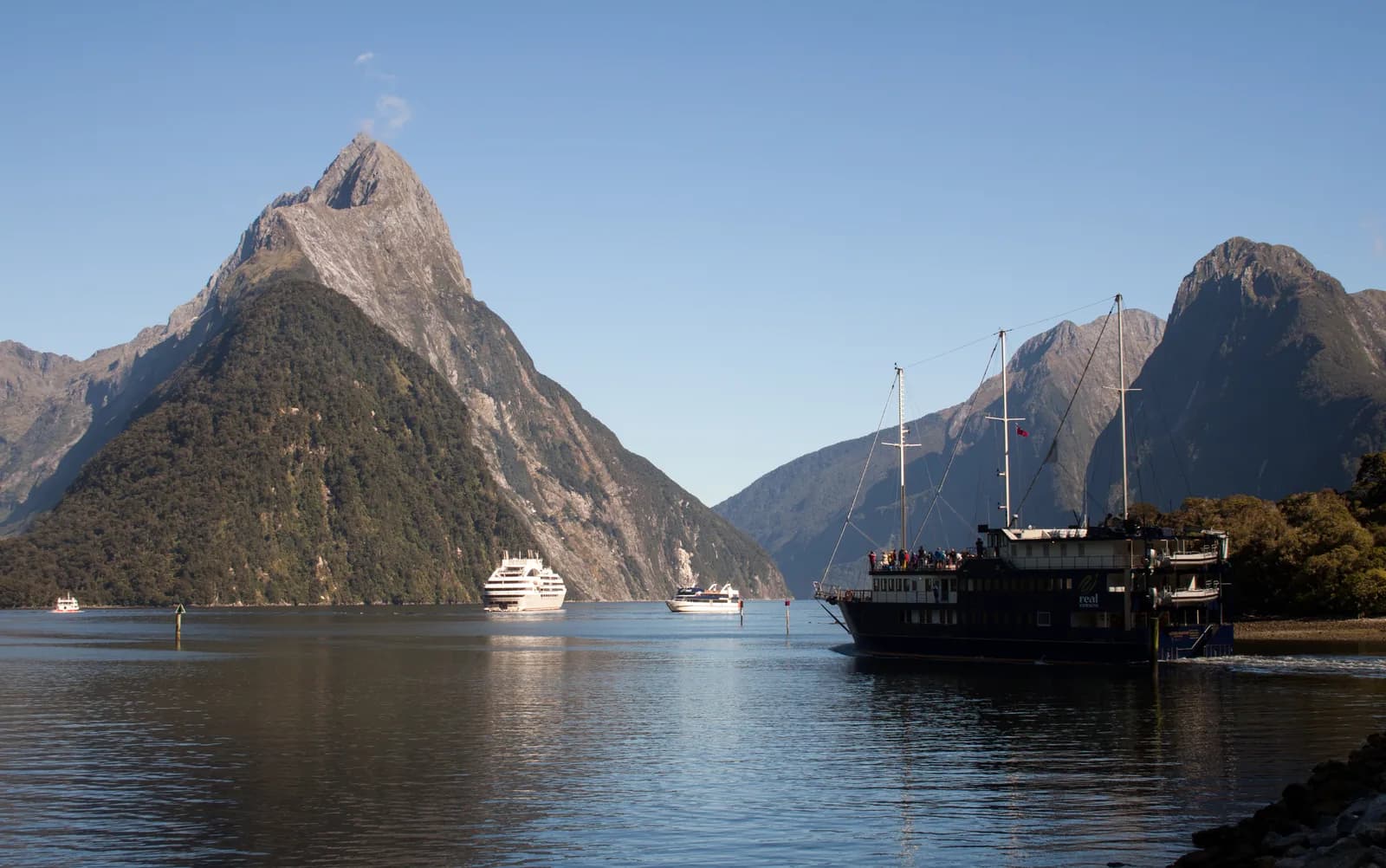 Mitre Peak rising over Milford Sound with cruise boats, New Zealand