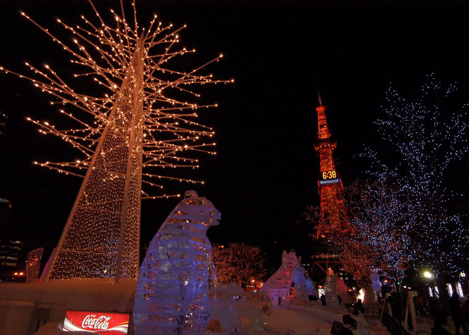 Illuminated trees and ice sculptures leading to the Sapporo TV Tower during the Snow Festival