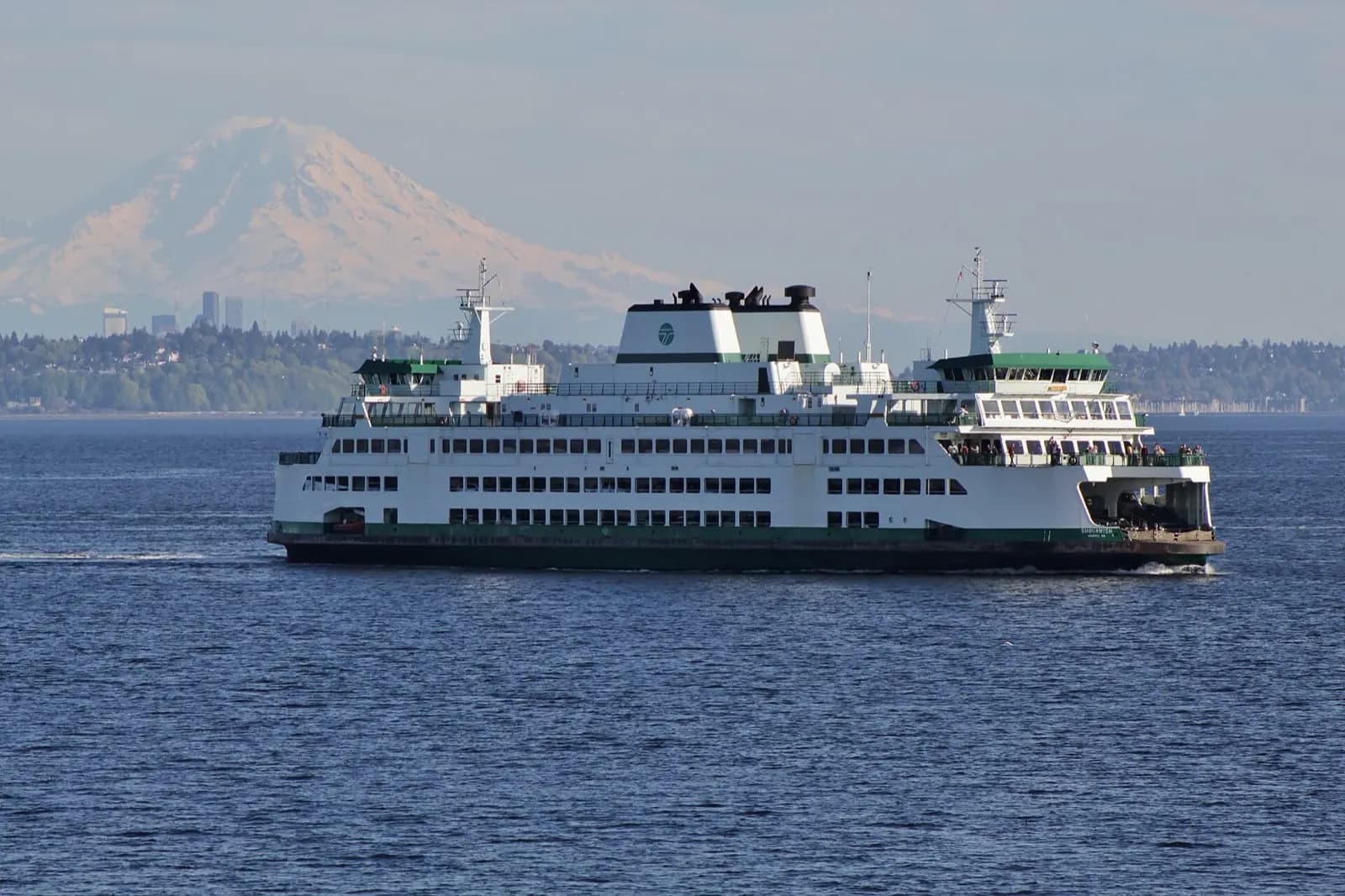 The Seattle skyline with Mount Rainier behind and a ferry crossing Puget Sound