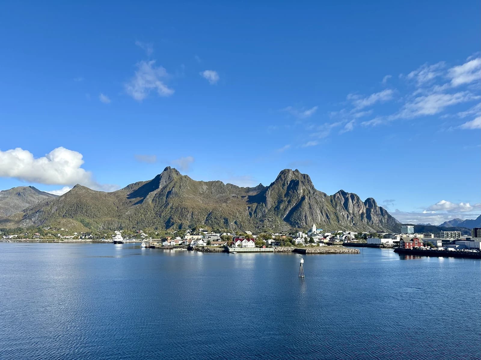 The town of Svolvaer along the water in Lofoten, under the steep rock walls that ring the harbour