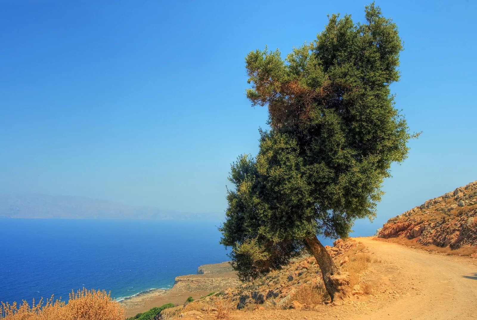 An empty road on Crete's south coast between the mountains and the sea