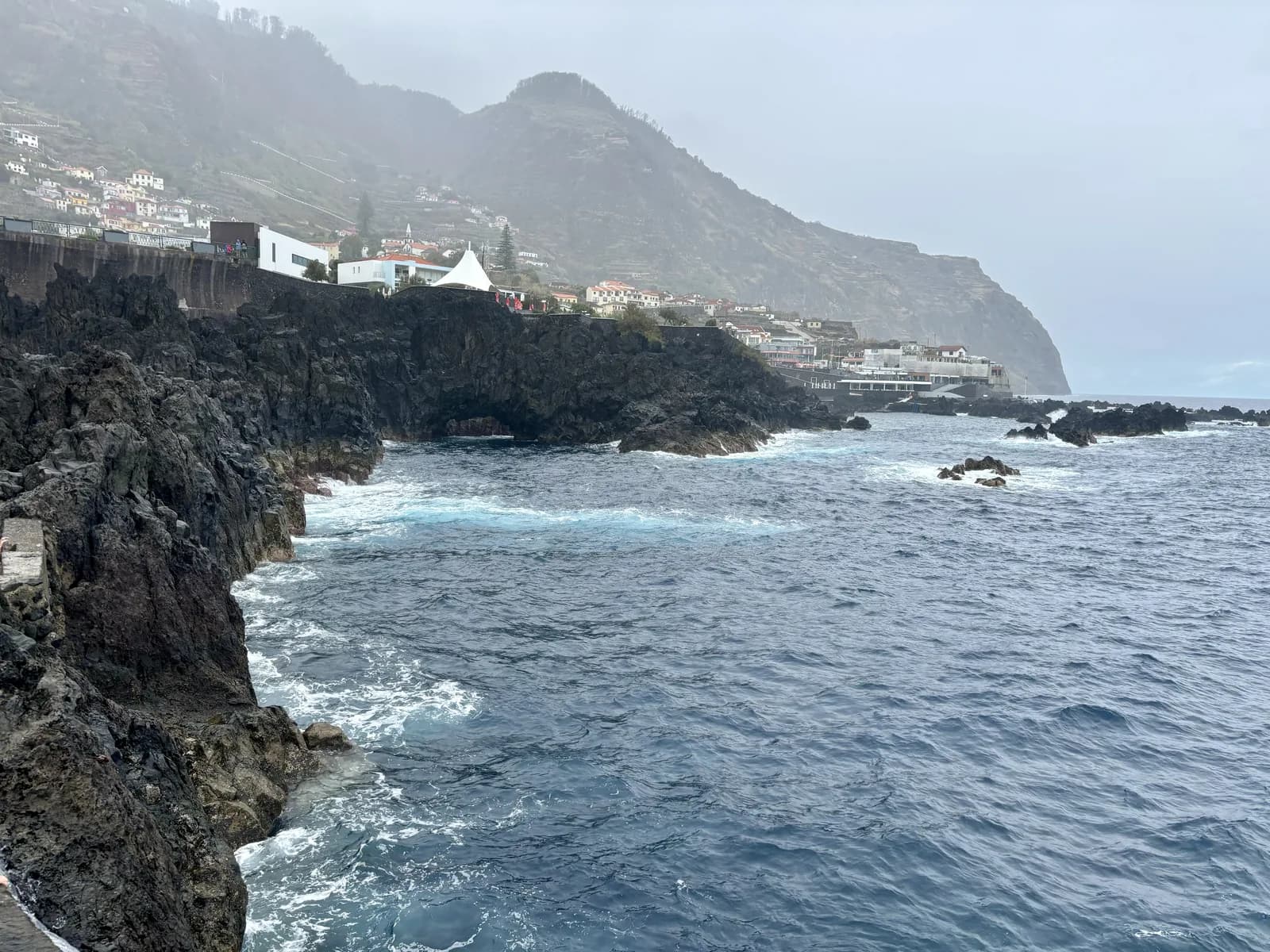 Cliffs and green slopes meeting the Atlantic on Madeira's north coast at Porto Moniz