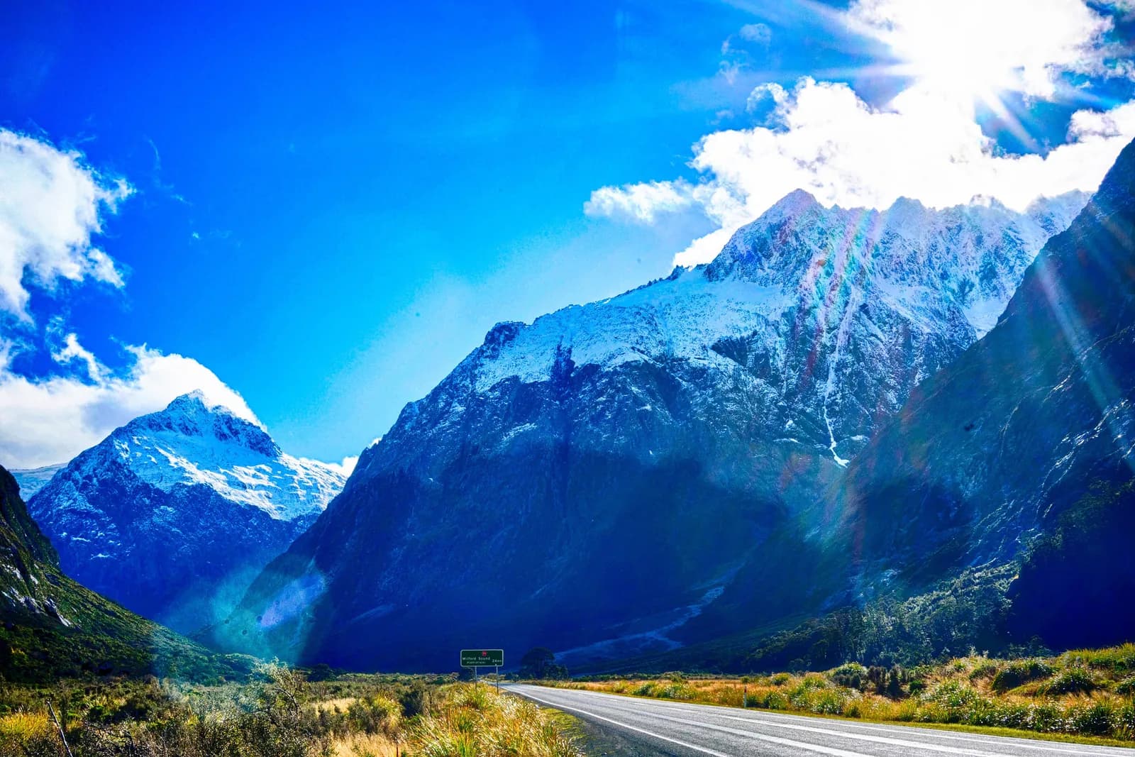 The road to Milford Sound heading toward snow-capped mountains