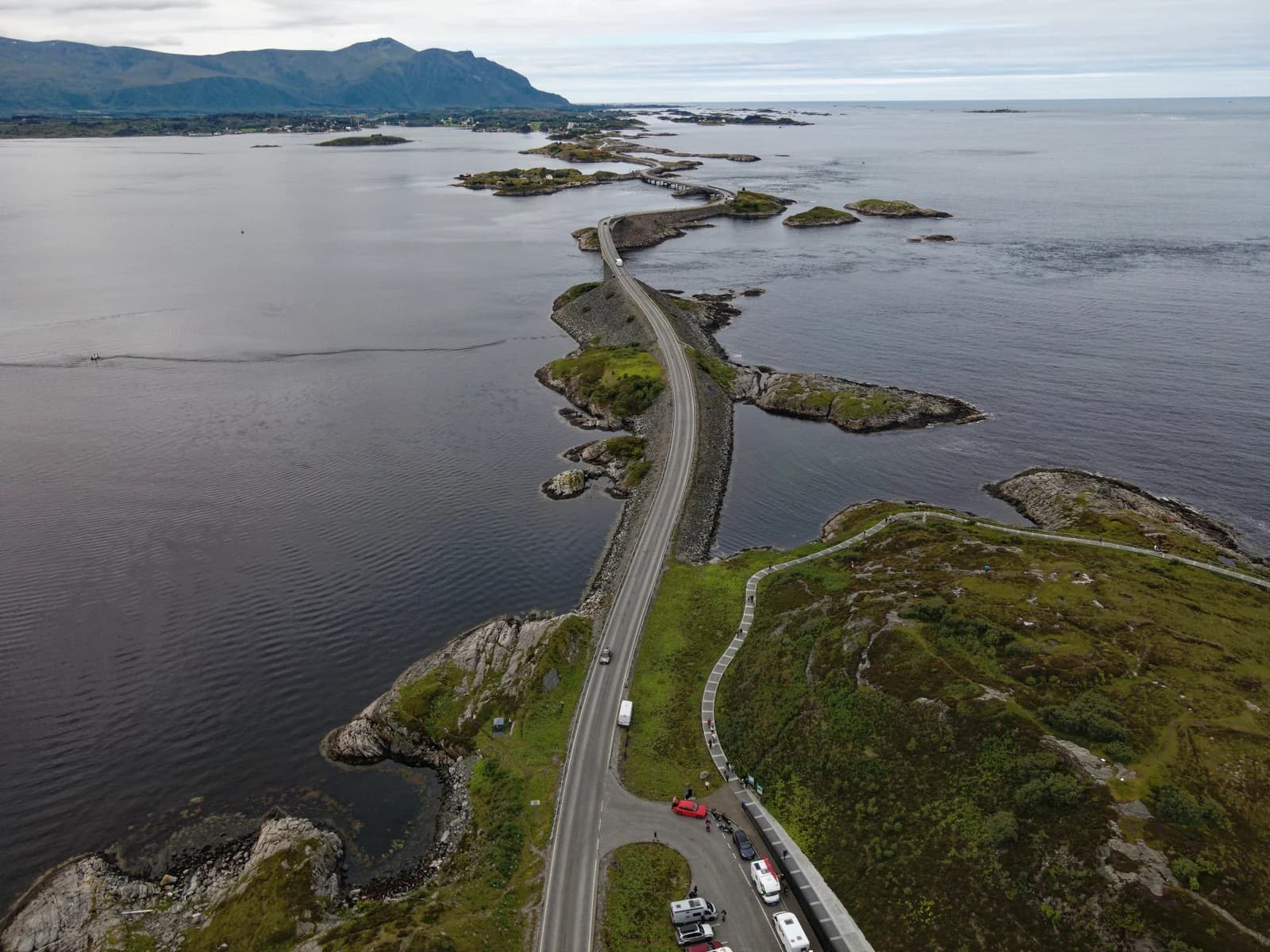 The Atlantic Road in Norway curving between low islets, its arched bridge rising over open water