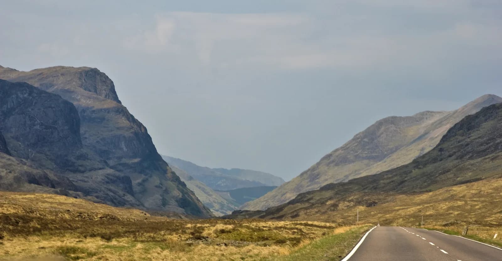 The open A82 road heading into Glen Coe past the Three Sisters mountains