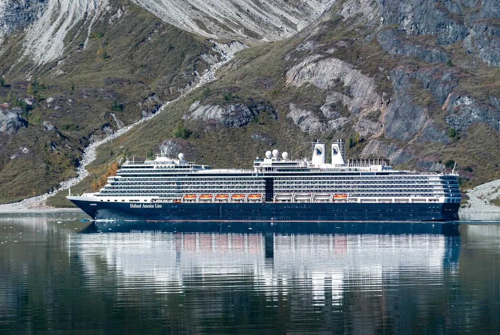 A cruise ship in Glacier Bay National Park, Alaska, with snow-covered mountains behind