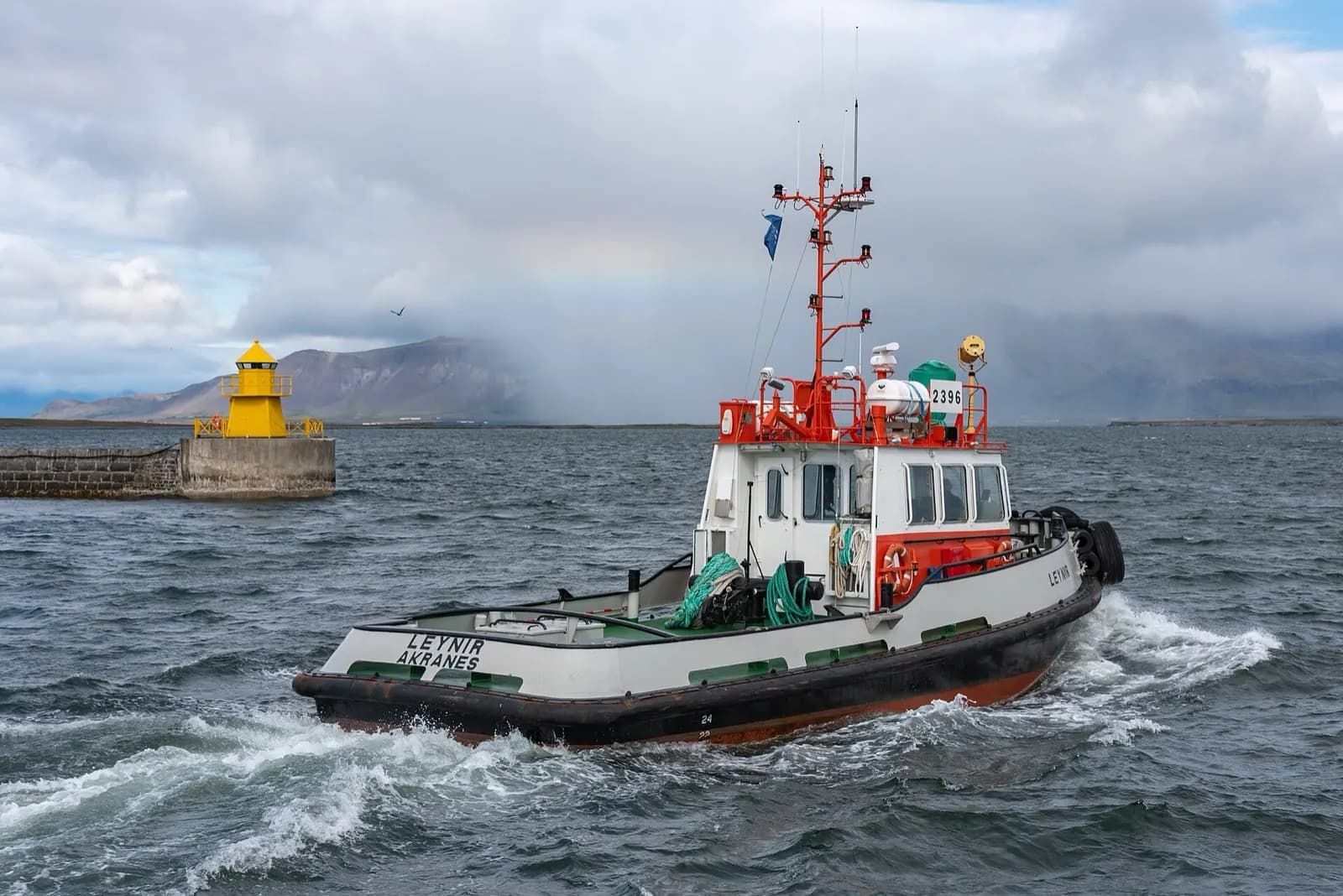A ship moored in Reykjavik harbour, Iceland, with mountains across the bay