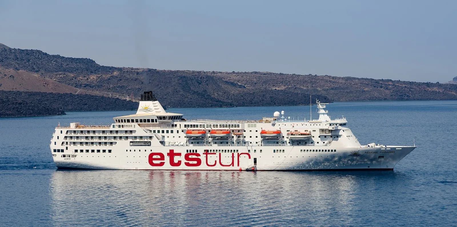 A cruise ship anchored in the Santorini caldera below the cliffs of Fira