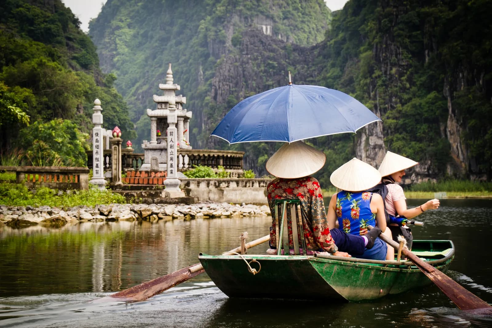 A rowed sampan between the karst at Tam Coc in Ninh Binh, the best day trip from Hanoi