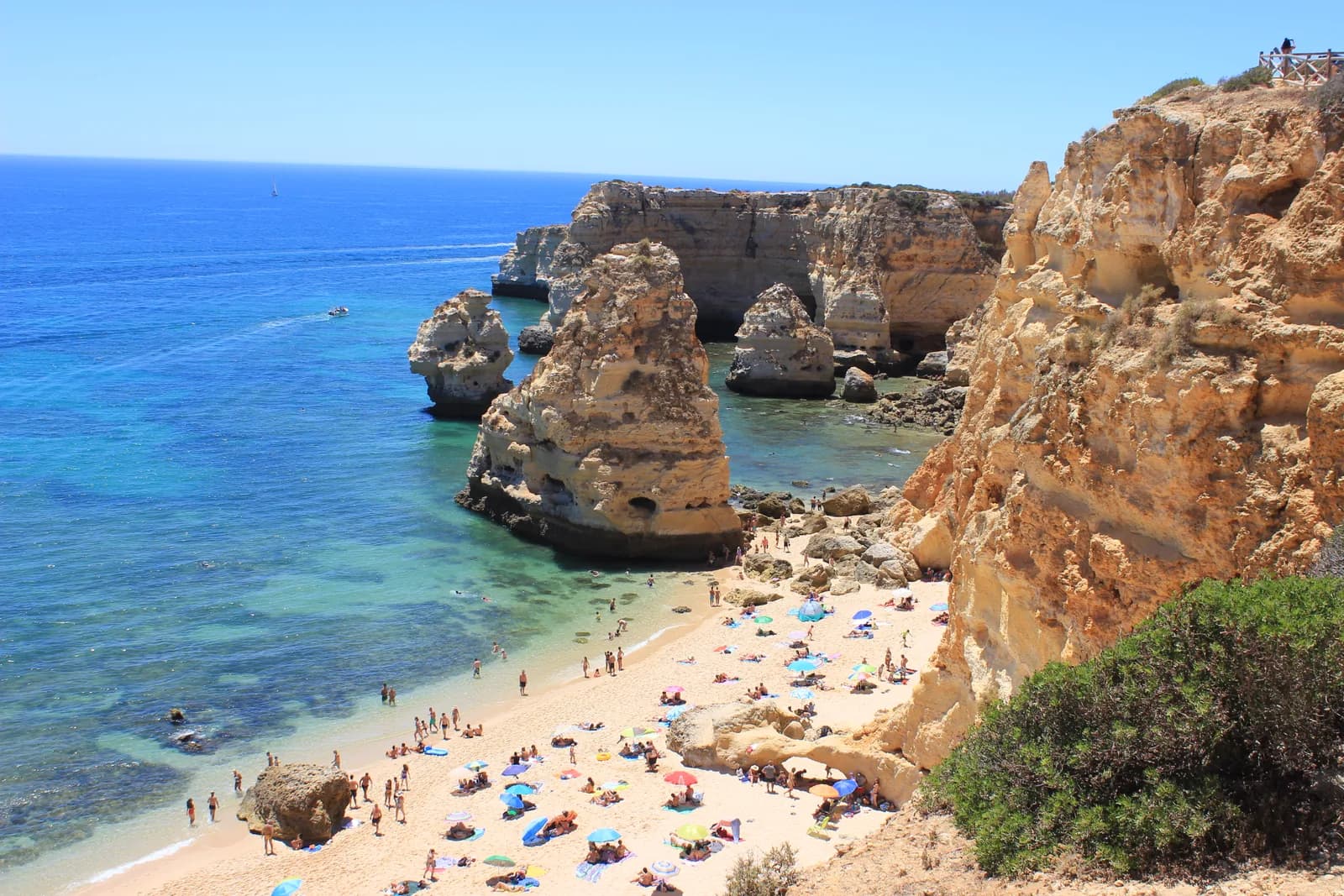 Praia da Marinha on the Algarve coast, with sea stacks, golden cliffs and families on the sand