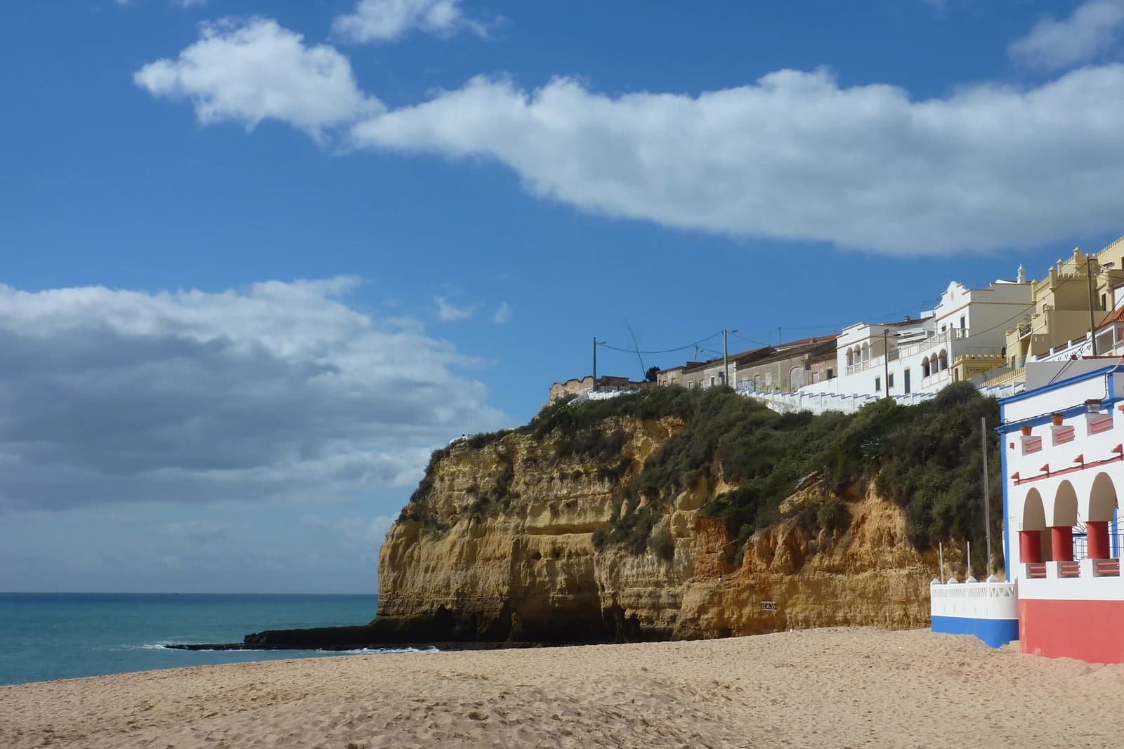 Whitewashed houses on the cliff above the beach at Carvoeiro