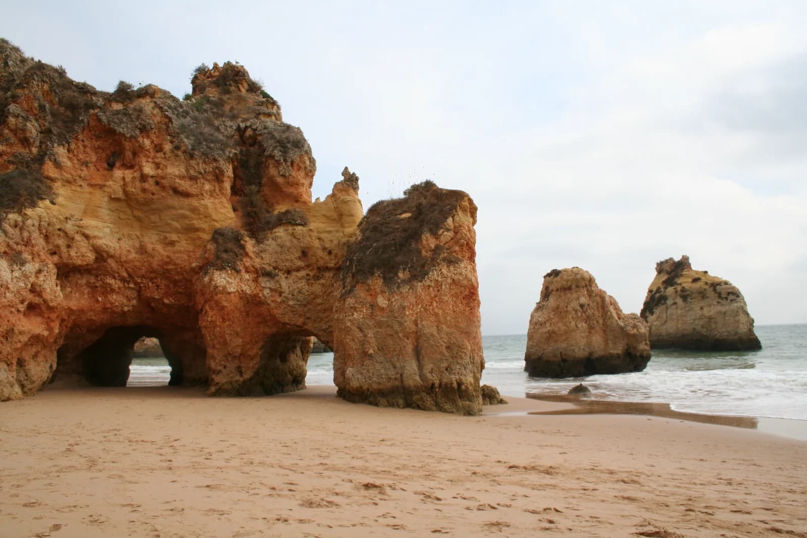 Rock arches and sea stacks on Praia dos Tres Irmaos at Alvor