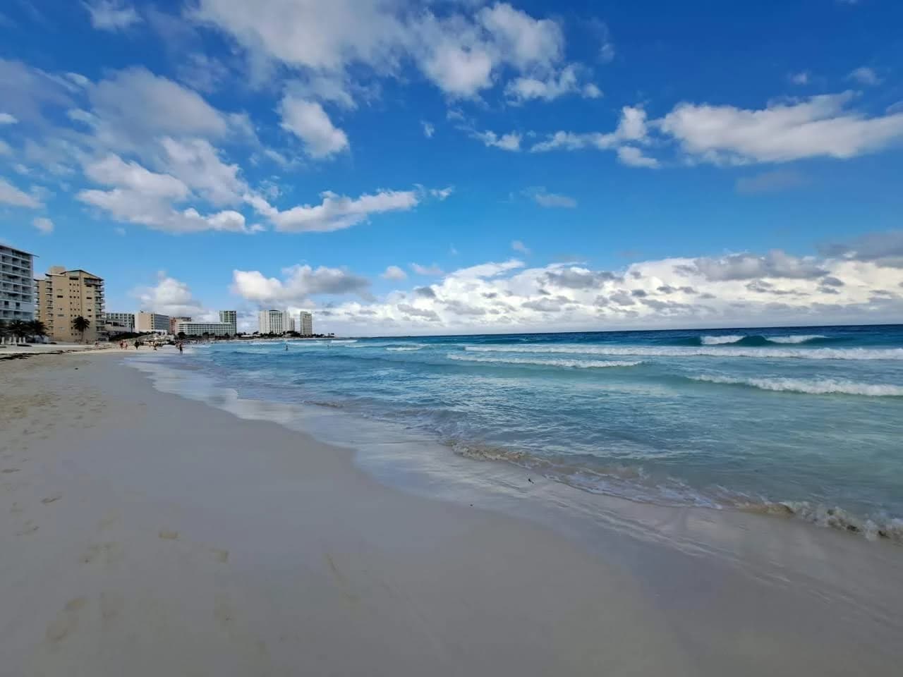 Playa Tortugas, a public beach at km 6.4 of Cancun's Hotel Zone, with hotels along the sand