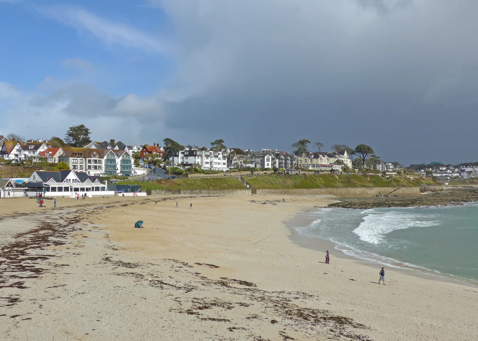 Gyllyngvase Beach in Falmouth with the seafront houses above the sand