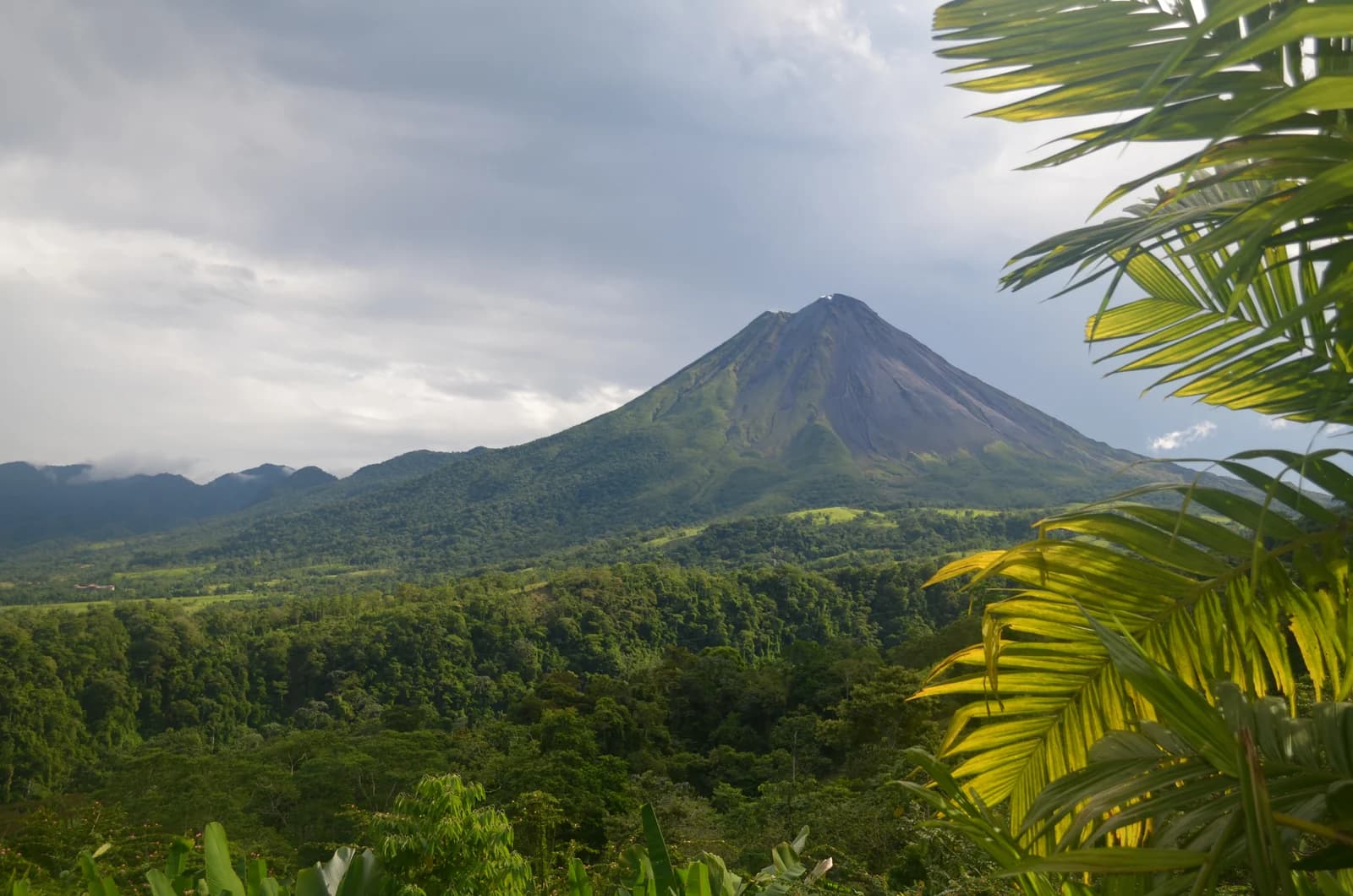 The cone of Arenal Volcano rising above rainforest in the Arenal valley