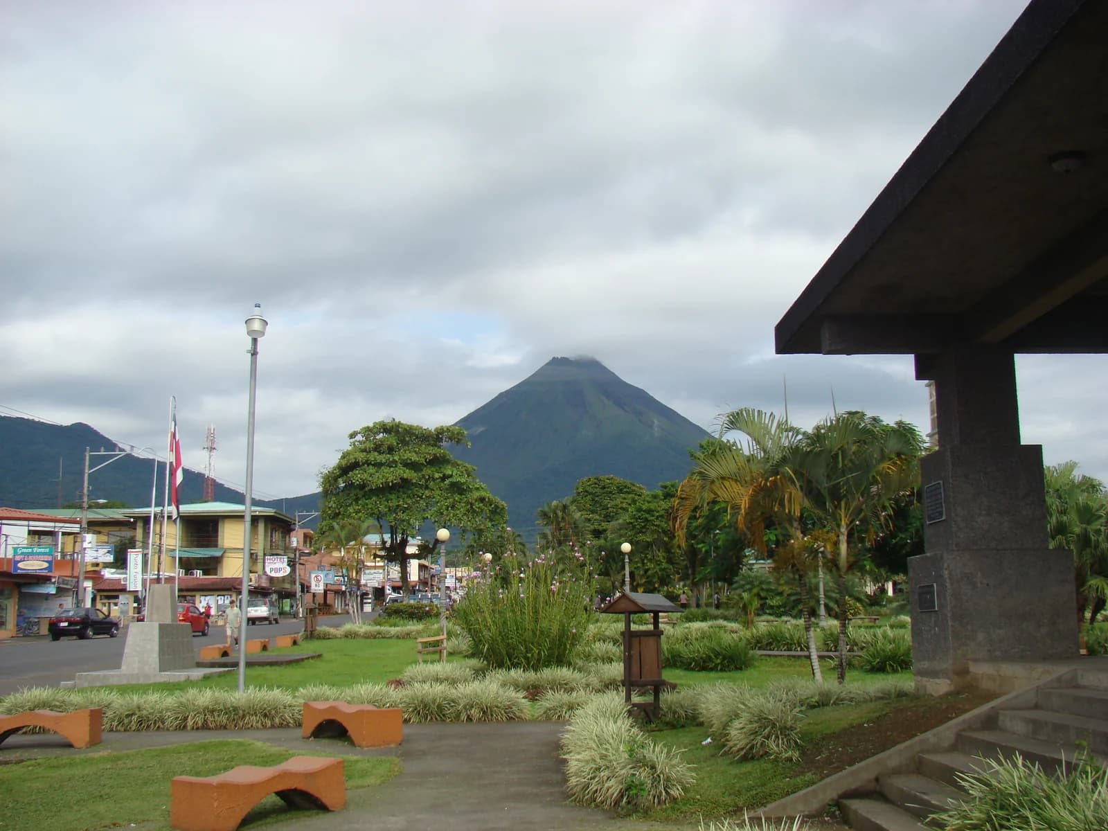 The central park of La Fortuna town with Arenal Volcano behind the main street