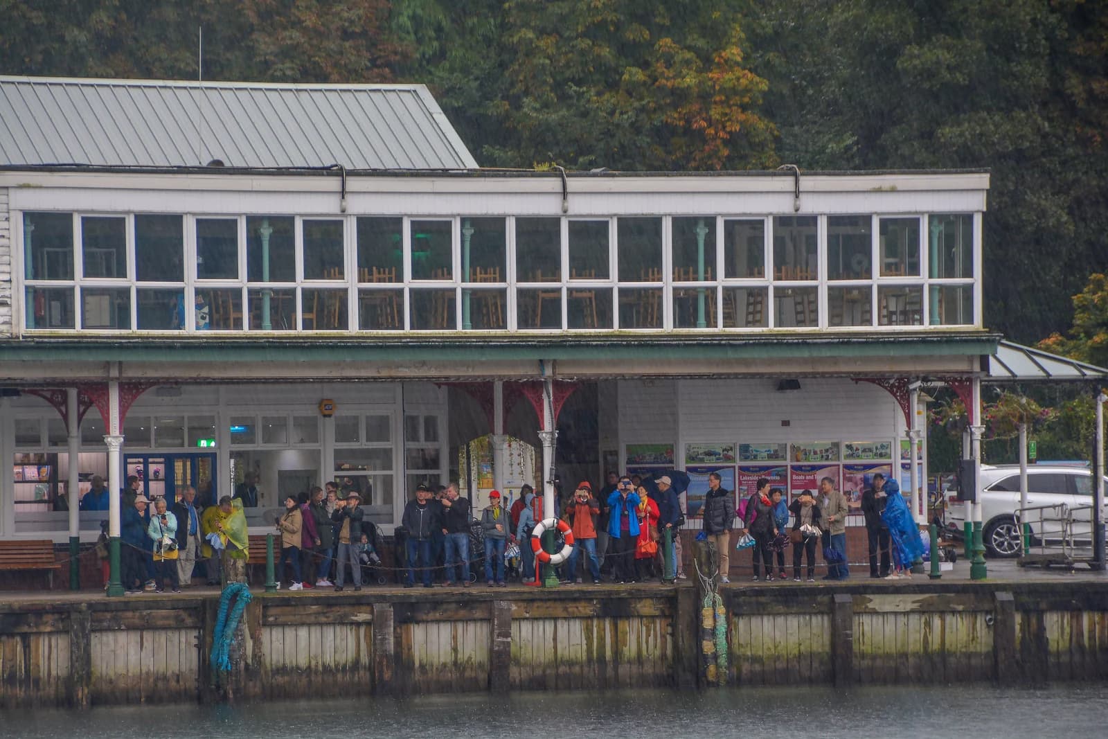 Passengers waiting under the canopy of the Lakeside landing stage at the southern end of Windermere