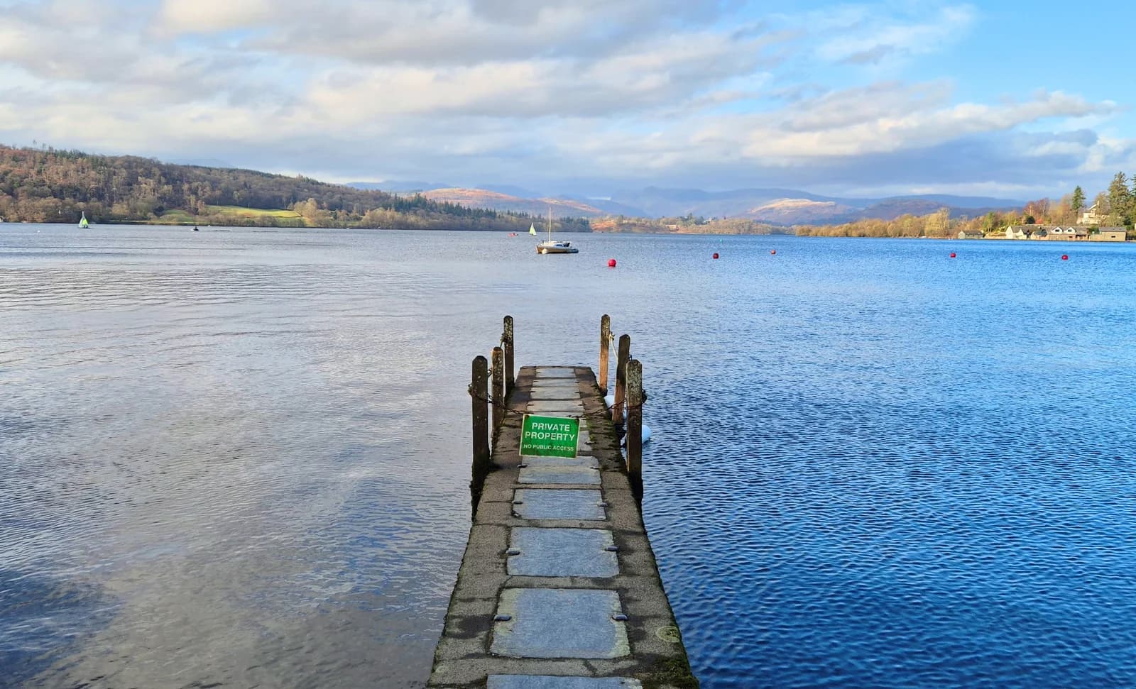 A stone jetty running out into Windermere at Low Millerground, north of Bowness
