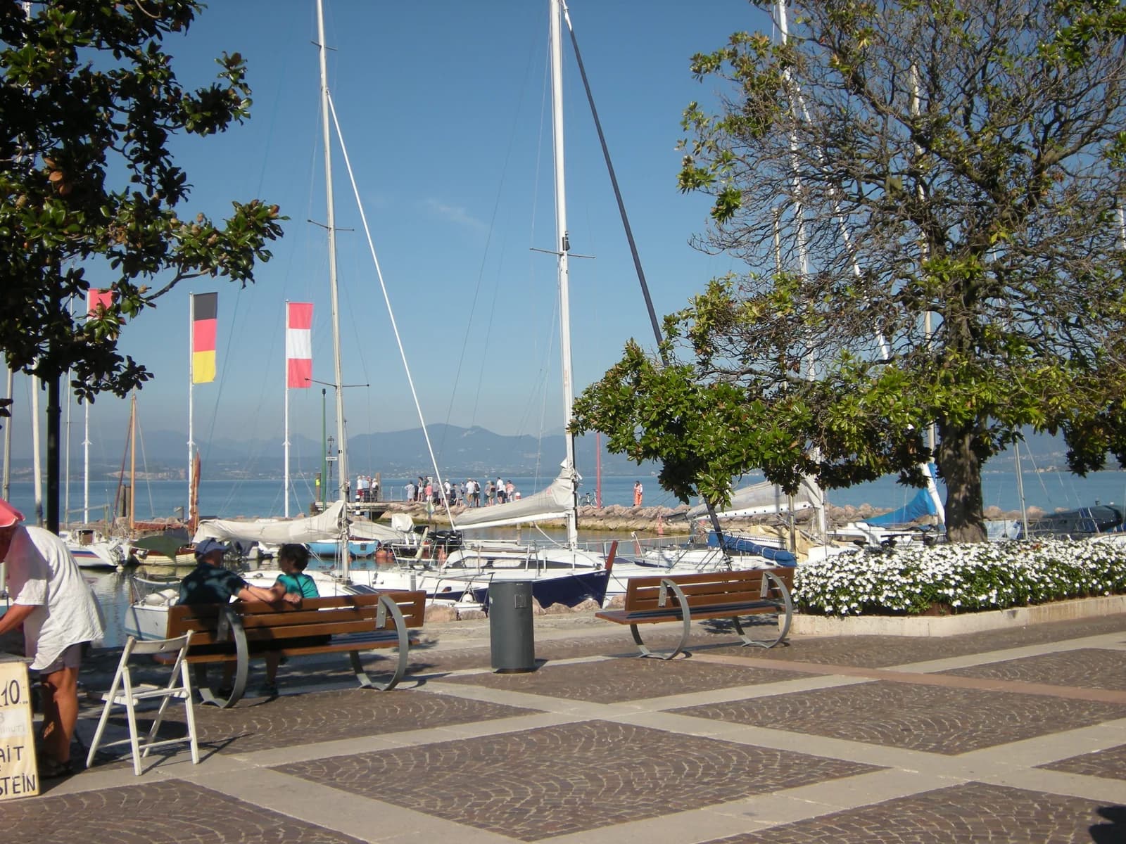 Benches on the lakeside square by the small harbour at Cisano, between Bardolino and Lazise