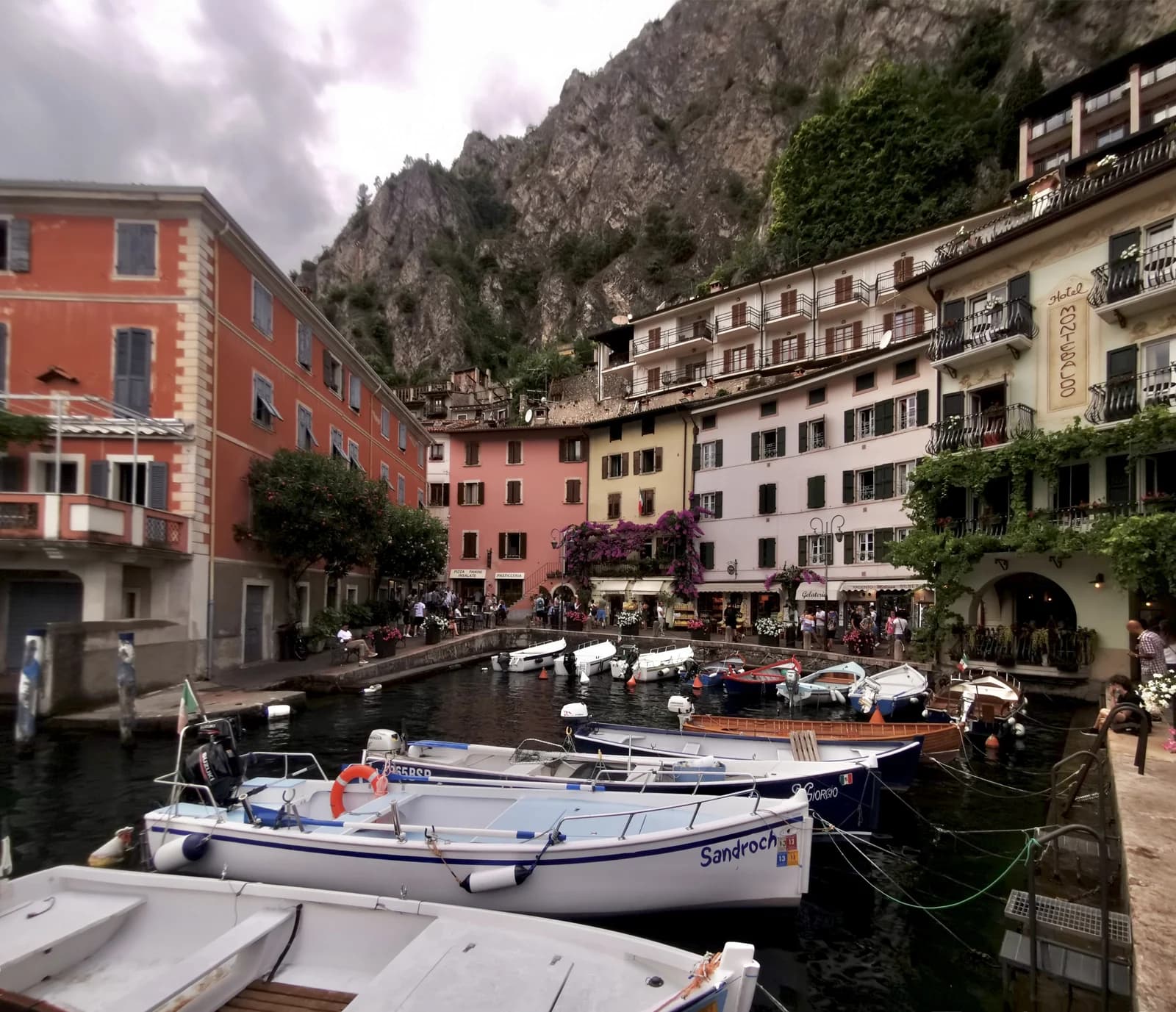 Boats in the little harbour of Limone sul Garda beneath the cliffs of the western shore