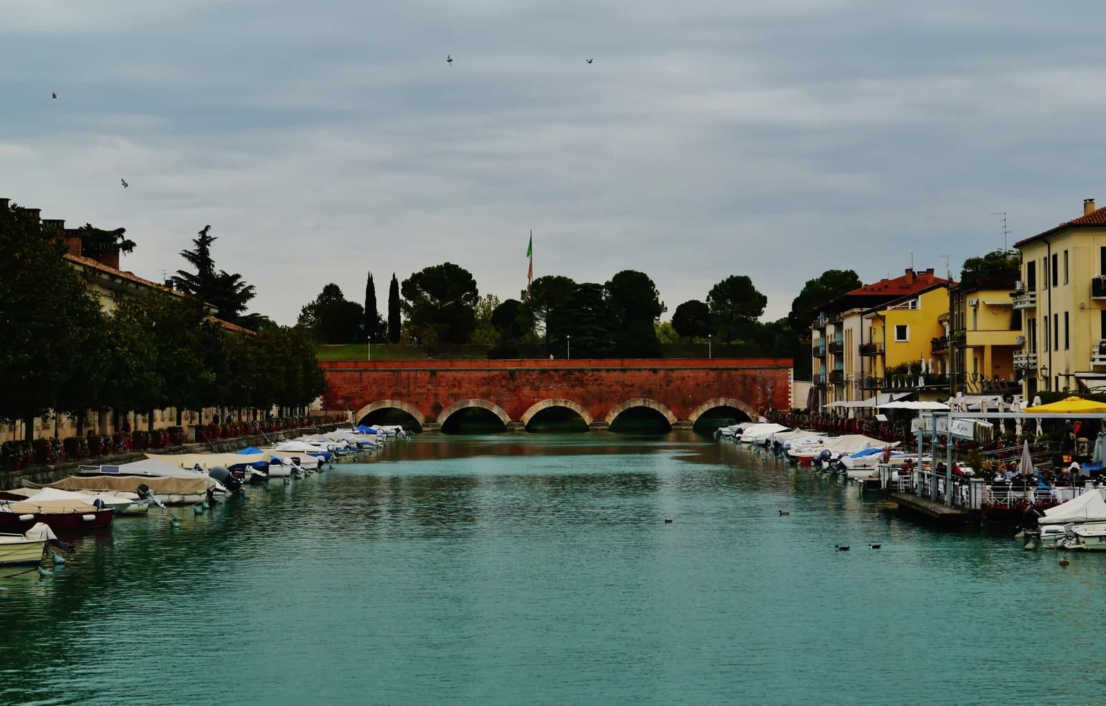 The brick Ponte dei Voltoni bridge over the canal in Peschiera del Garda