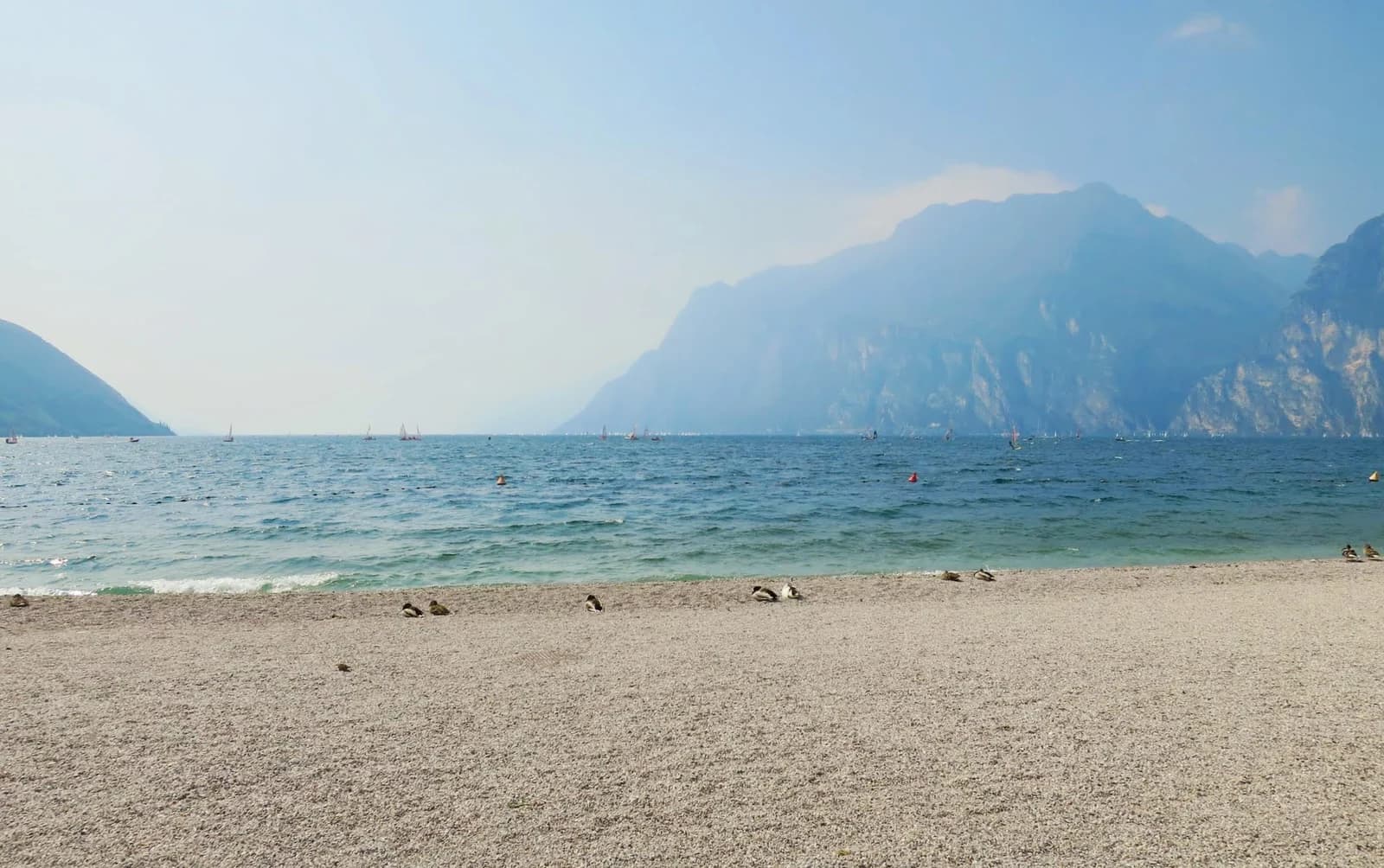 The gravel beach at Riva del Garda with the mountains of the northern lake behind