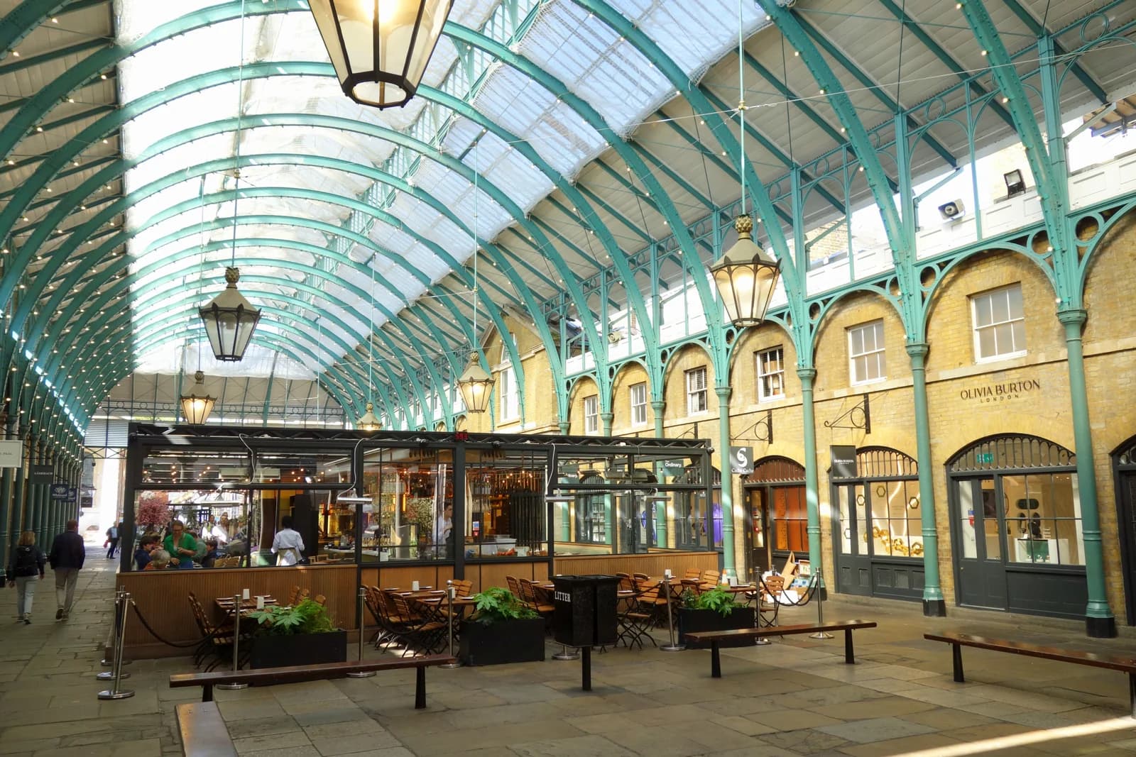Cafe tables under the iron and glass roof of Covent Garden Market