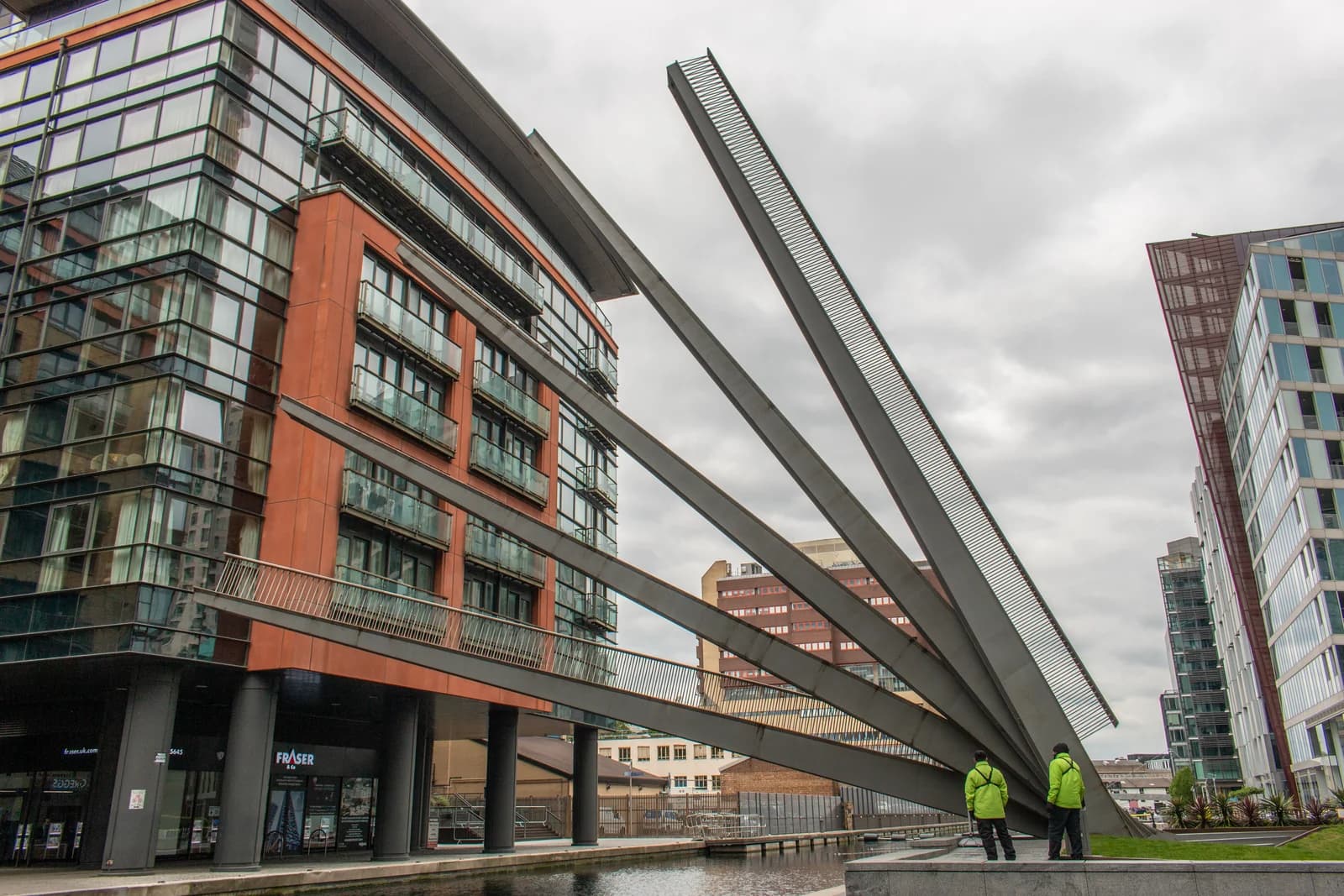 The raised steel arms of the Fan Bridge over the canal at Paddington Basin
