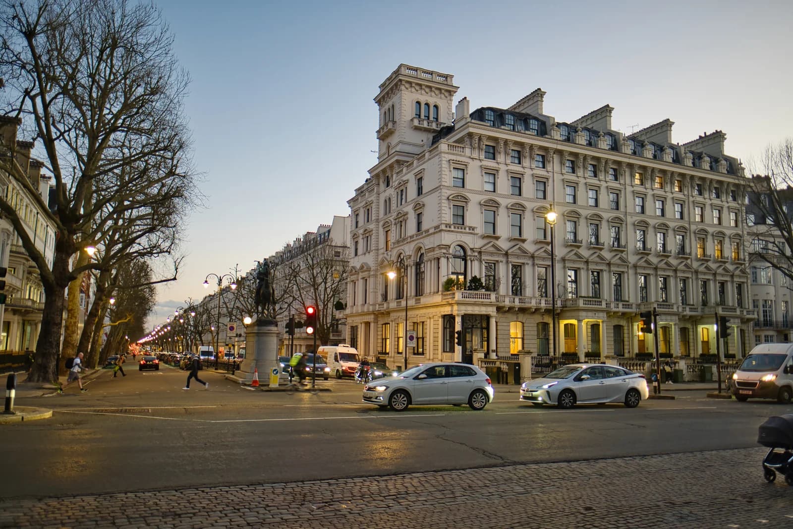 White stucco terraces where Queen's Gate meets Kensington Road at the park end of the street