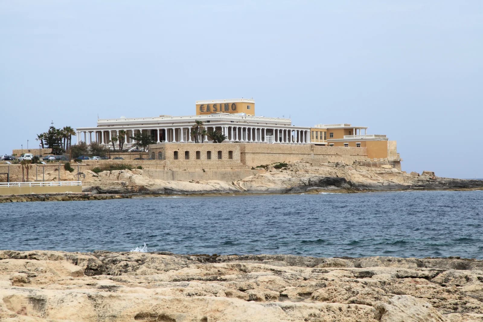 The old Dragonara Palace on the rocky point at the edge of St Julian's