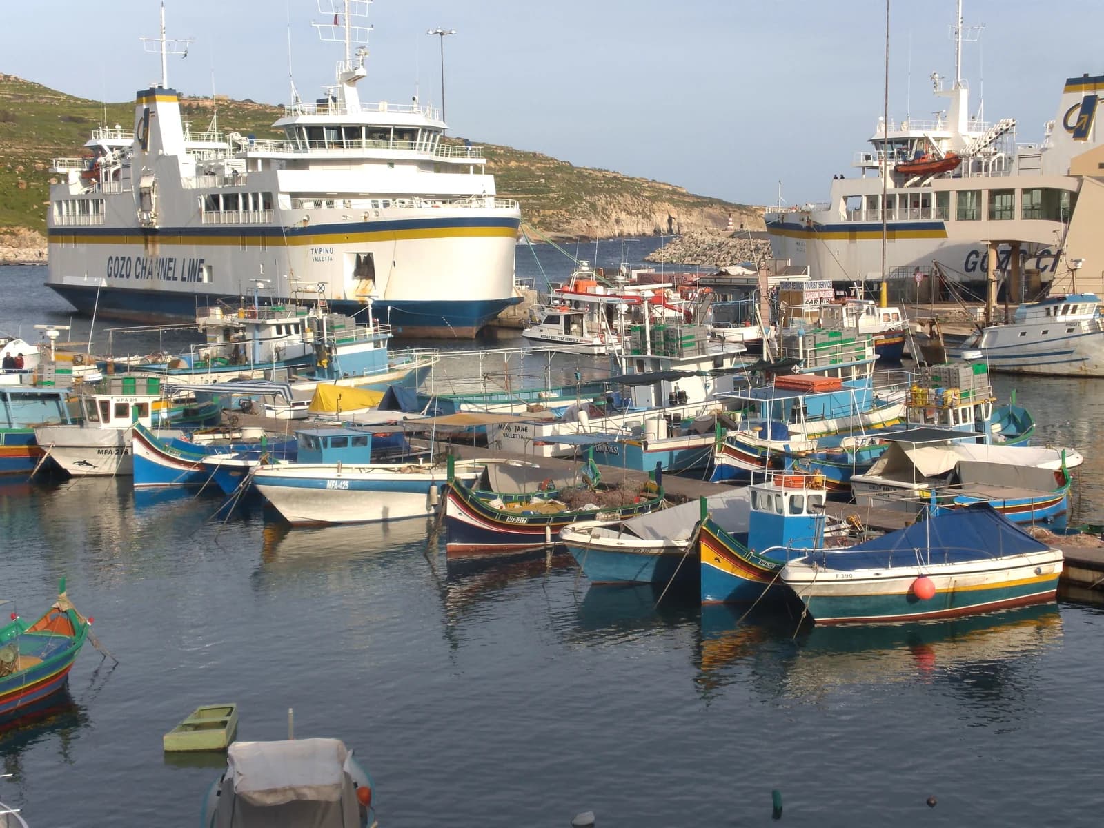 Gozo Channel ferries and fishing boats in Mġarr harbour on Gozo