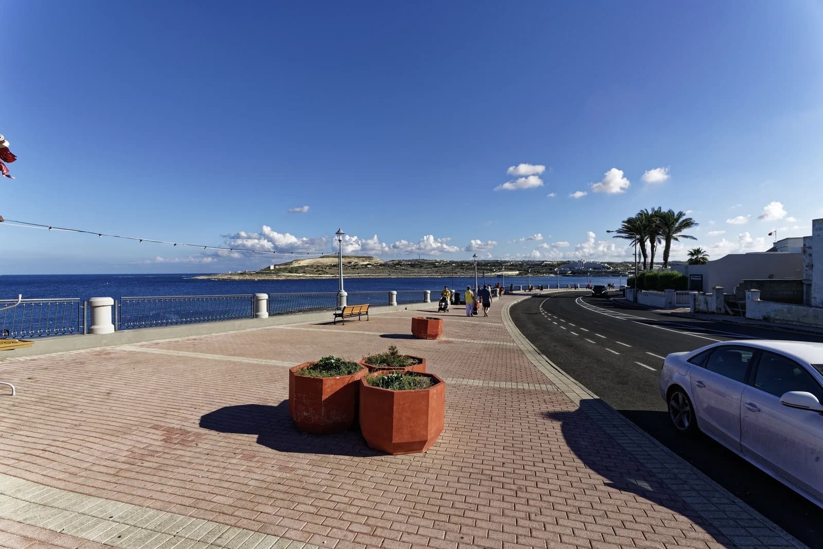 The wide seafront promenade along the Qawra coast road