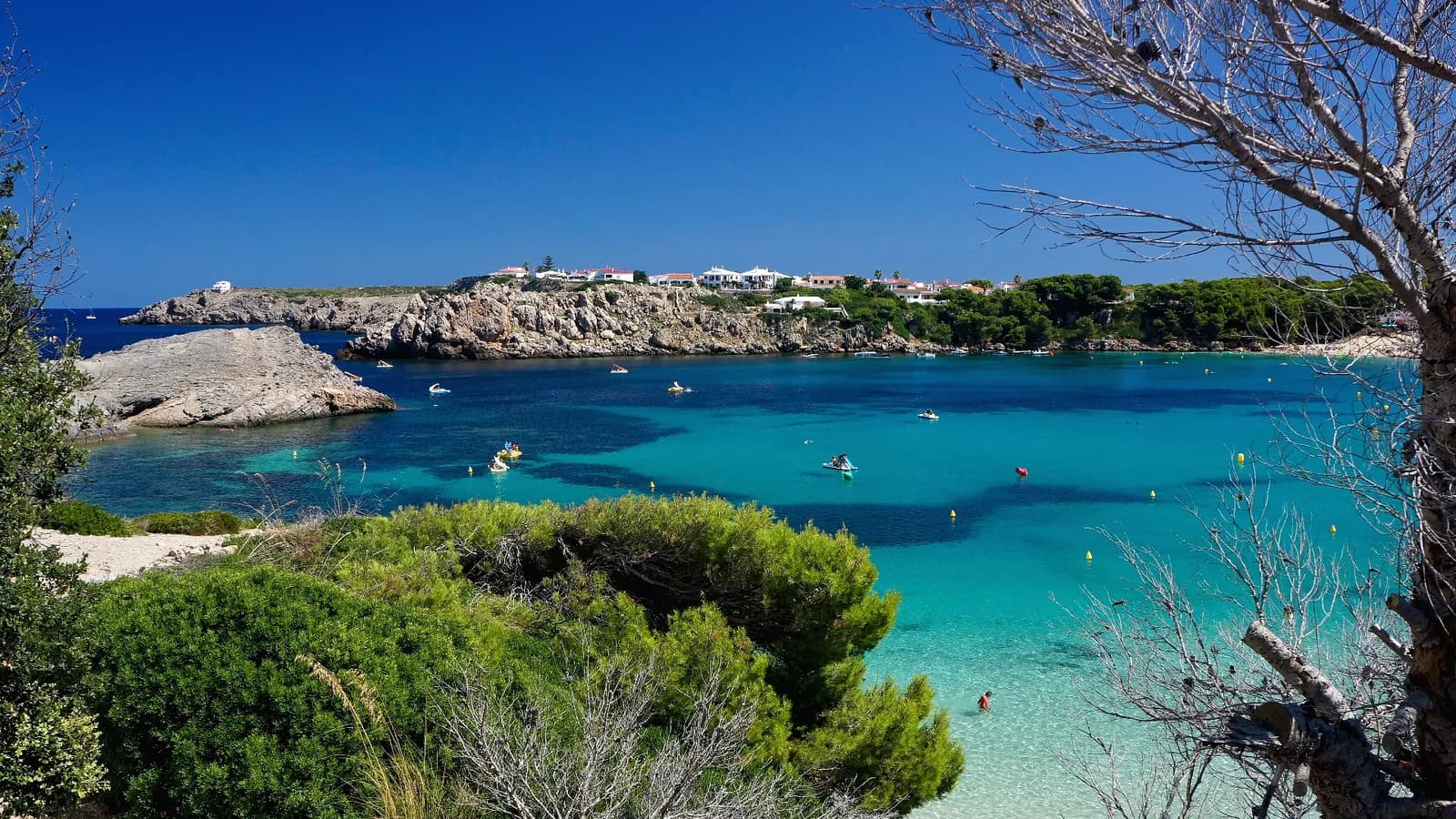 Turquoise water in the bay at Arenal d'en Castell on Menorca's north coast