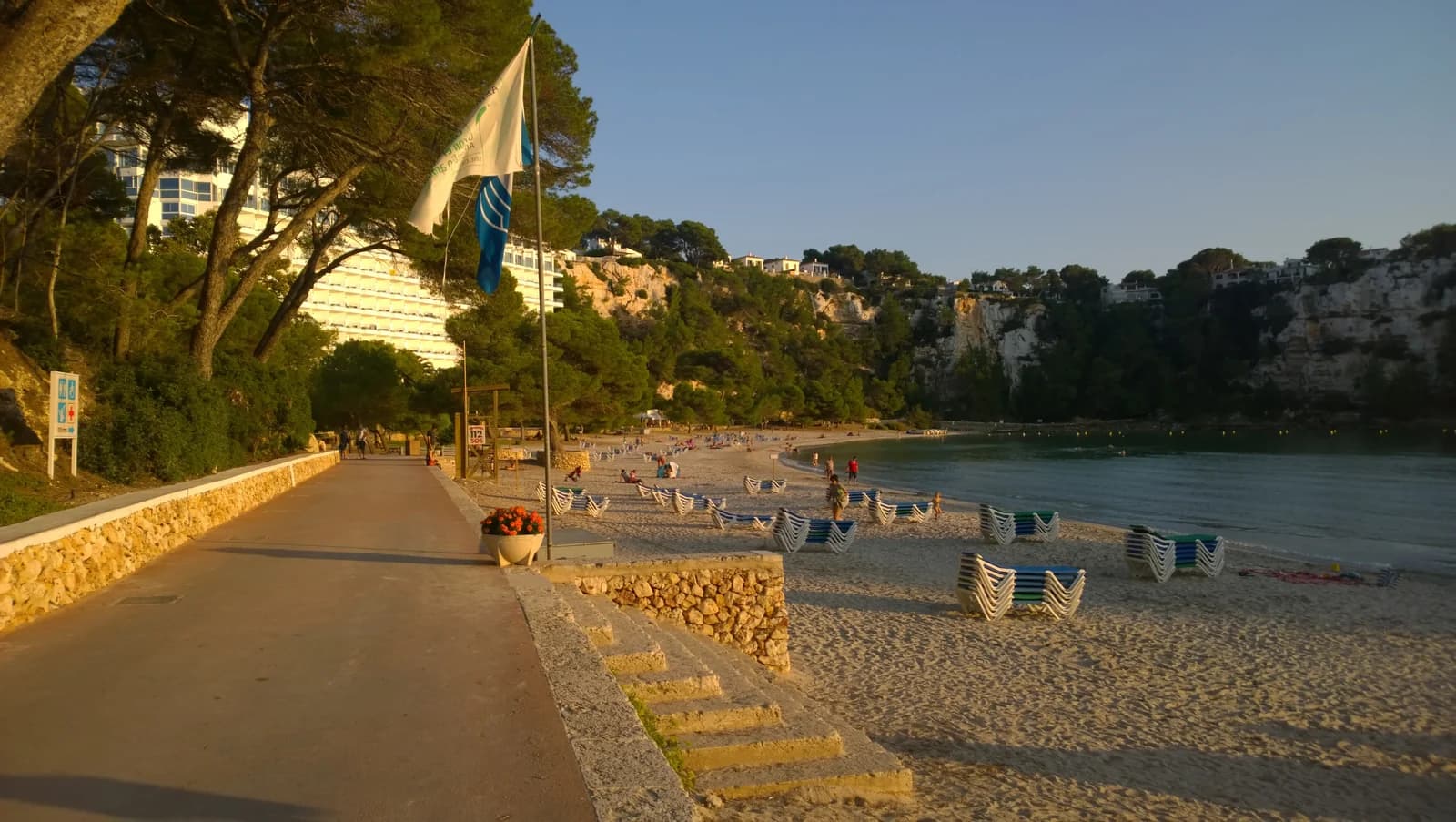 The promenade beside the sand at Cala Galdana in the evening sun