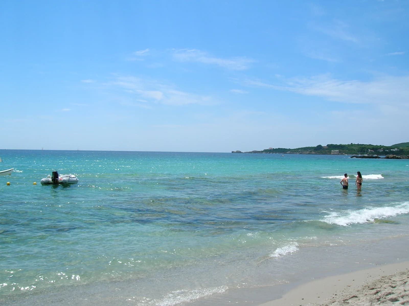 Clear shallow water at Le Bombarde beach near Alghero