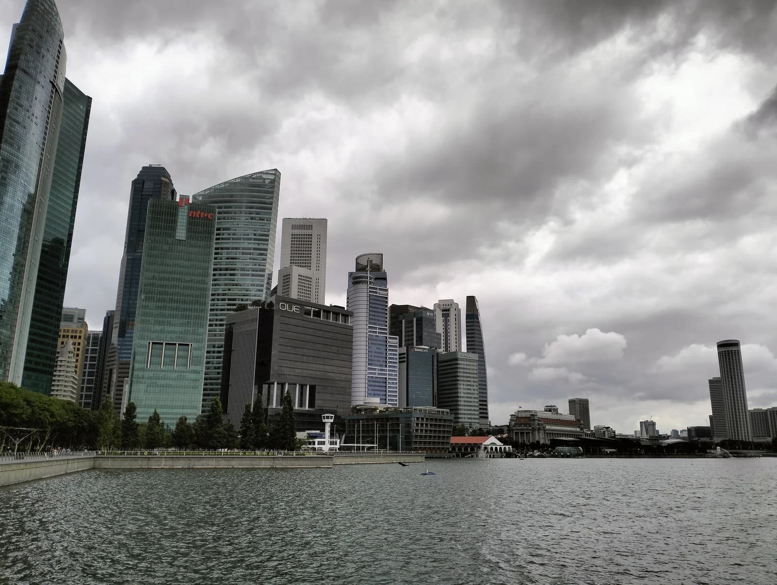 The towers of the Marina Bay waterfront reflected in the water